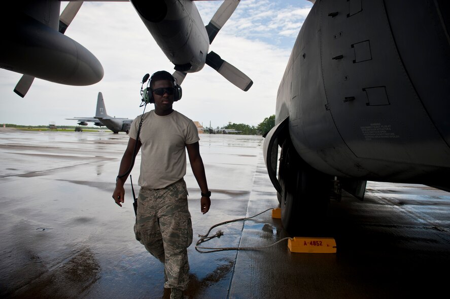 U.S. Air Force Senior Airman Justin Davis, 723rd Aircraft Maintenance Squadron crew chief, walks to complete his next task after setting chalks on an HC-130P Combat King at Moody Air Force Base, Ga., July 27, 2011. (U.S. Air Force photo by Staff Sgt. Jamal D. Sutter/Released)