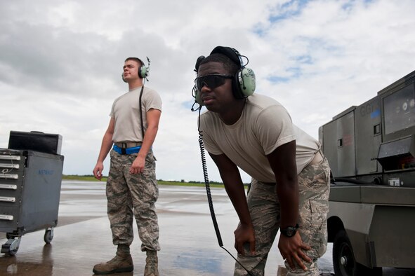 U.S. Air Force Airman 1st Class Anthony Davis, left, and Senior Airman Justin Davis, 723rd Aircraft Maintenance Squadron crew chiefs, wait as an HC-130P Combat King taxis in at Moody Air Force Base, Ga., July 27, 2011. Having the same last name, co-workers of the two jokingly calls them “The D-Team” when working together. (U.S. Air Force photo by Staff Sgt. Jamal D. Sutter/Released)