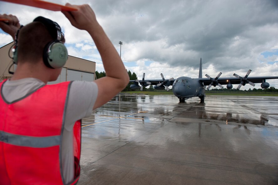 U.S. Air Force Airman 1st Class Anthony Davis, 723rd Aircraft Maintenance Squadron crew chief, marshals in an HC-130P Combat King at Moody Air Force Base, Ga., July 27, 2011. Davis has only been at Moody for two months and it is his first base. Performing small maintenance and preparing aircraft for flight and recovery are primary duties of crew chiefs. (U.S. Air Force photo by Staff Sgt. Jamal D. Sutter/Released)