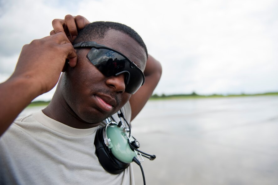 U.S. Air Force Senior Airman Justin Davis, 723rd Aircraft Maintenance Squadron crew chief, applies ear protection in preparation for an incoming HC-130P Combat King at Moody Air Force Base, Ga., July 27, 2011. Davis has been stationed at Moody for five years and it is his first base. (U.S. Air Force photo by Staff Sgt. Jamal D. Sutter/Released)