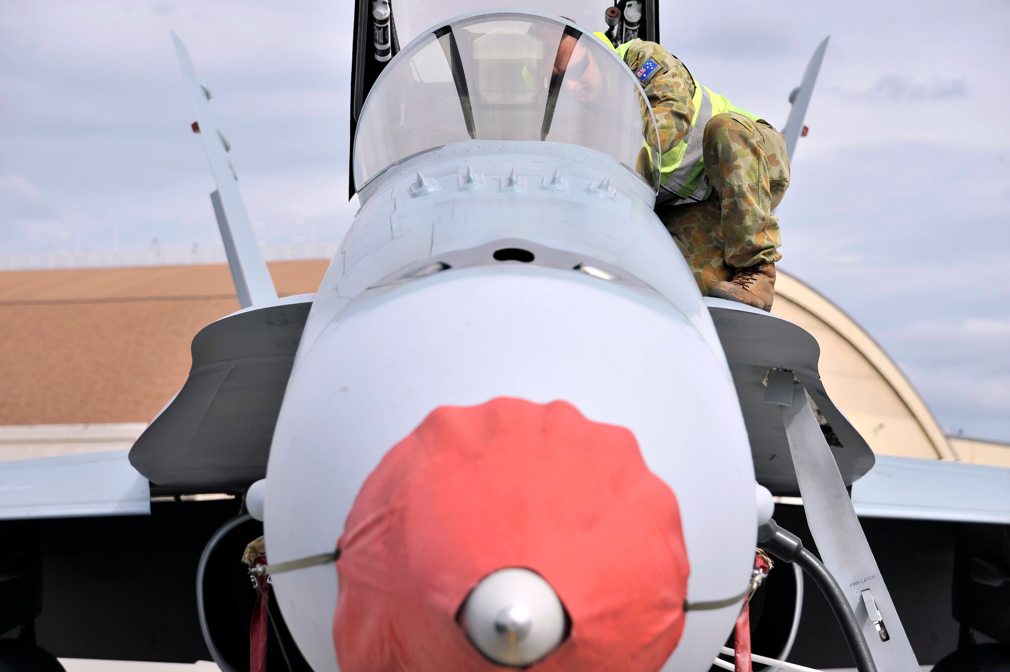 A Royal Australian Air Force maintainer checks aircraft diagnostics on an F/A-18 Hornet July 15, 2011, Eielson Air Force Base, Alaska.  Maintainers travel with the F/A-18 Hornet to ensure they meet standards in reliability and serviceability, especially during RED FLAG-Alaska.  RF-A participants also utilize exercises as an opportunity to have less -experienced Airmen get valuable on-the-job training.   (U.S. Air Force photo by/Staff Sgt. Christopher Boitz)
