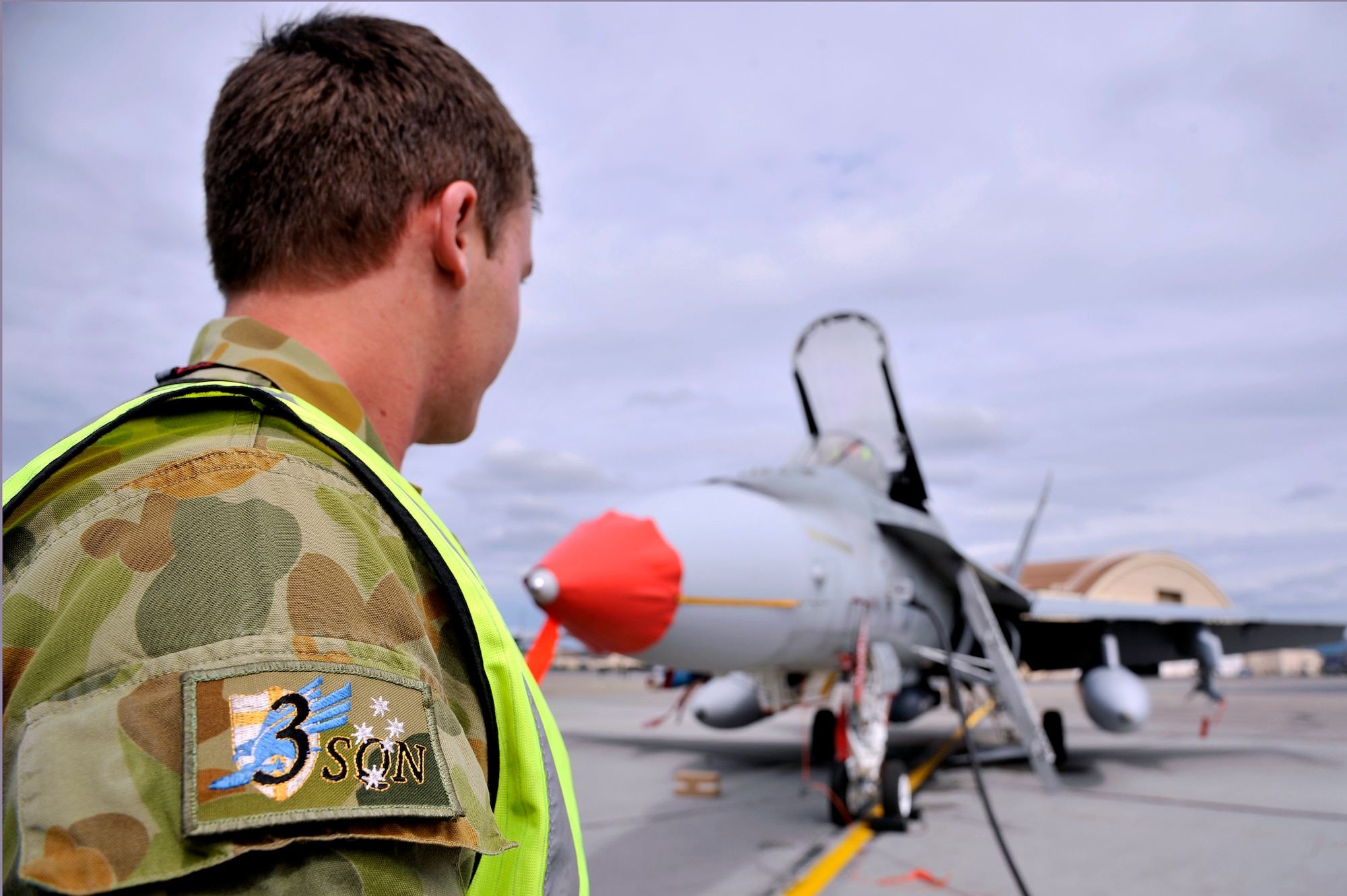 A Royal Australian Air Force maintainer monitors a generator connection to an F/A -18 Hornets July 15, 2011, Eielson Air Force Base, Alaska.  RED FLAG-Alaska 11-2 presented a steady stream of missions for RAAF maintainers to gain experience on the F/A-18 Hornet and learn how other countries perform aircraft maintenance and keep their fighter jets mission capable during the two-week exercise.  RF-A participants receive an opportunity to learn from one another and improve the overall performance of people and equipment.    (U.S. Air Force photo by/Staff Sgt. Christopher Boitz)