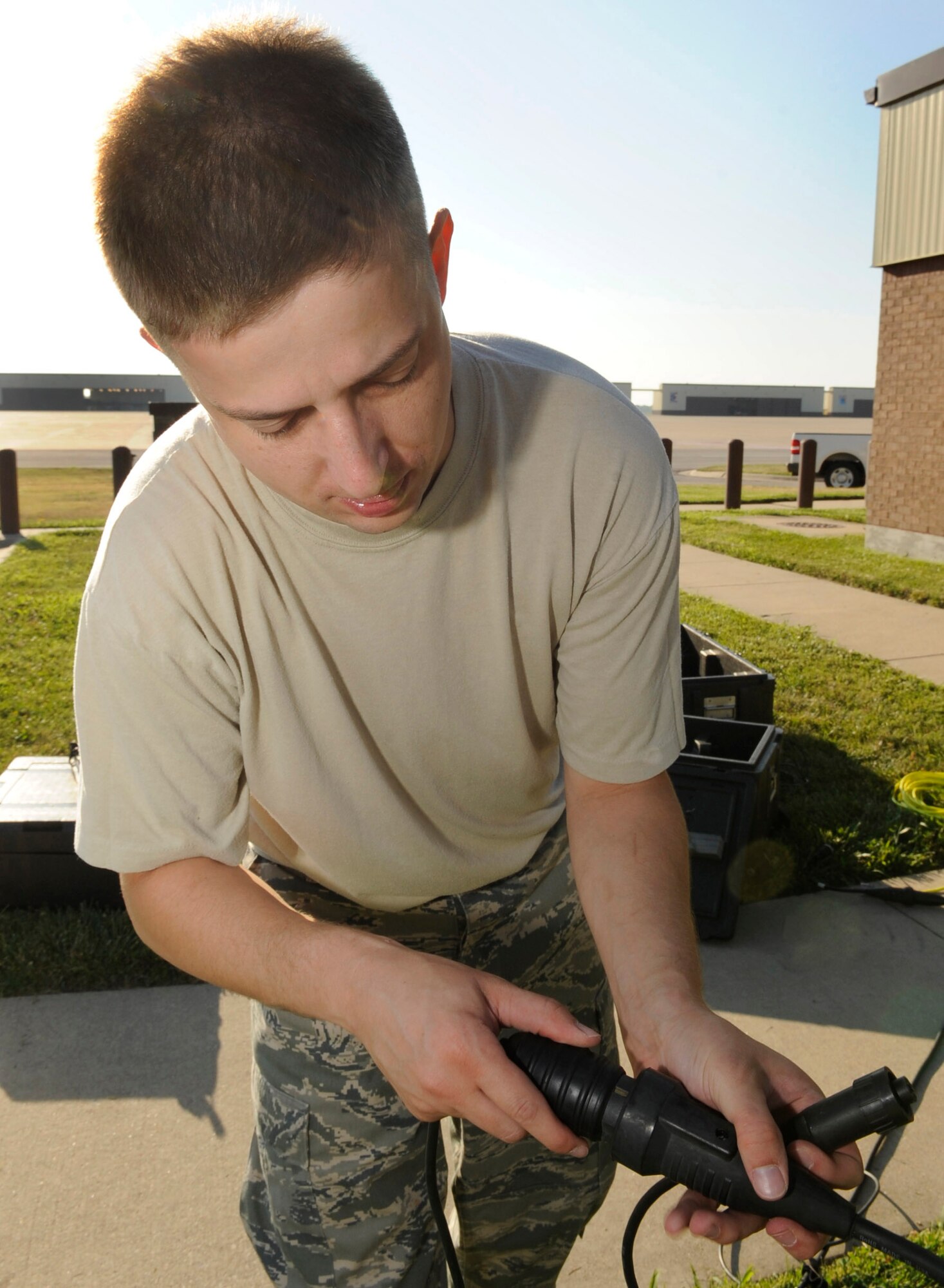 WHITEMAN AIR FORCE BASE, Mo. -- Staff Sgt. Ryan Watts, 509th Operations Support Squadron weather training NCO in charge, plugs the tactical meteorological observing systems in a power source here July 20. Sergeant Watts performs a preventative maintenance inspection on the weather equipment. The equipment can operate using solar power and be positioned for 30 days without a power source. (U.S. Air Force photo by Senior Airman Alexandra M. Boutte) (RELEASED)