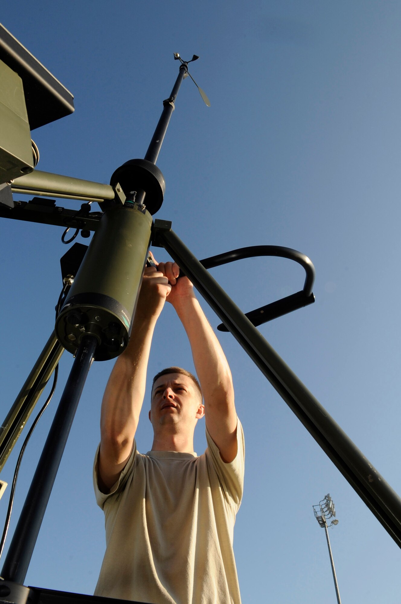 WHITEMAN AIR FORCE BASE, Mo. -- Staff Sgt. Ryan Watts, 509th Operations Support Squadron weather training NCO in charge, plugs the tactical meteorological observing systems in a power source here July 20. The suite of automatic tactical weather sensors provides an automated collection of weather elements in deployed environments. Two Airmen can set up the equipment and within 30 minutes can be operational. (U.S. Air Force photo by Senior Airman Alexandra M. Boutte) (RELEASED)