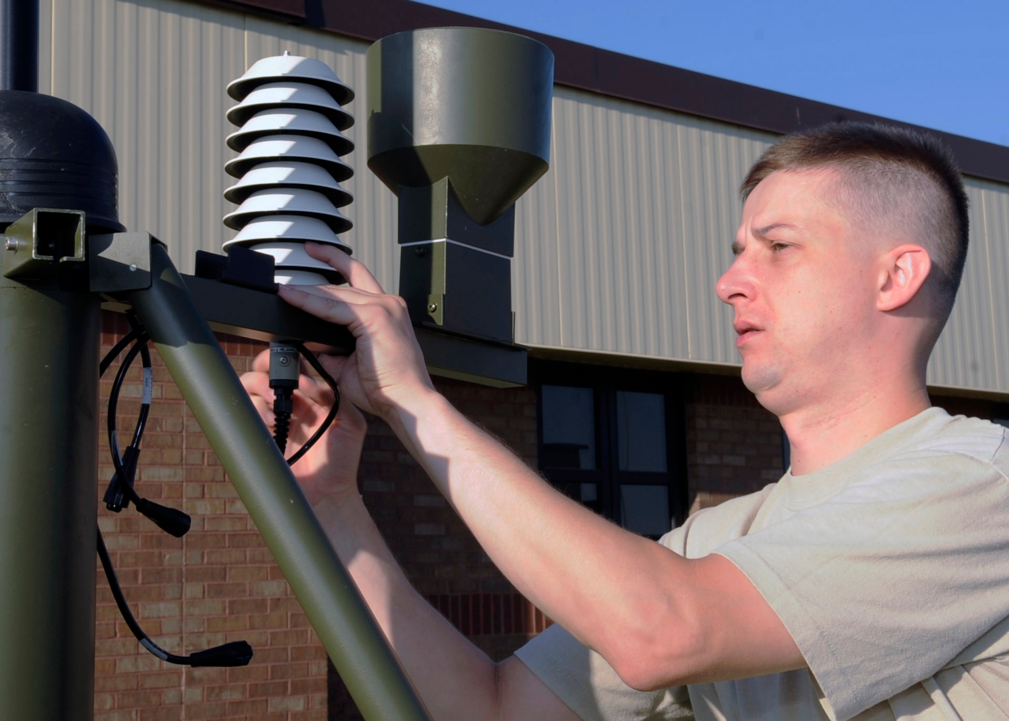 WHITEMAN AIR FORCE BASE, Mo. -- Staff Sgt. Ryan Watts, 509th Operations Support Squadron weather training NCO in charge, sets up the tactical meteorological observing systems to perform routine maintenance here July 20. The suite of automatic tactical weather sensors provides an automated collection of weather elements in deployed environments. (U.S. Air Force photo by Senior Airman Alexandra M. Boutte) (RELEASED)
