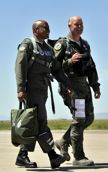 Col. Anthony Cotton (left) and Col. Pete Hronek stroll across the flightline to the aircraft hangar July 7. The two commanders from the east and west ends of Great Falls are good friends both on and off duty. (U.S. Air Force photo/John Turner)