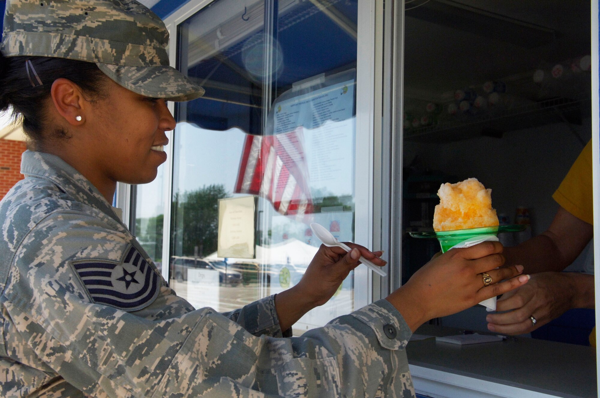 Tech. Sgt. Chassity Murray, U.S. Transportation Command, cools down with an icy treat July 21, 2011. (U.S. Air Force photo/ Samantha Crane)
