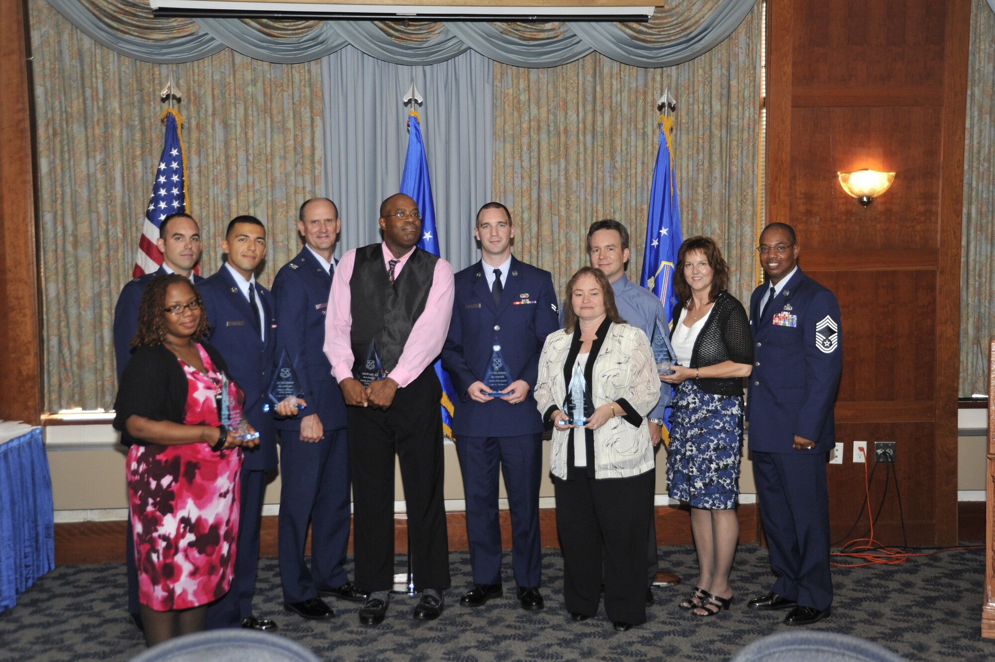 Air Force District of Washington Quarterly Award winners smile with their statues following a luncheon held in their honor July 20, 2011, at The Club on Joint Base Andrews, Md.