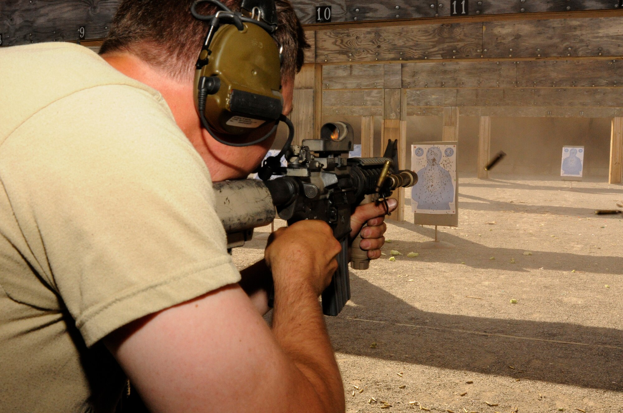 Senior Master Sgt. Henry Christle from Selfridge Air National Guard Base, 107 Weather Flight Special Operations Weather Team unloads the magazine of his M-4 rifle into the target during the annual Gray Wolverine training exercise held at Combat Readiness Training Center Alpena, Mich., July 21, 2011. Christle is the superintendent of the 107th.  (U.S. Air Force photo by TSgt David Kujawa) 