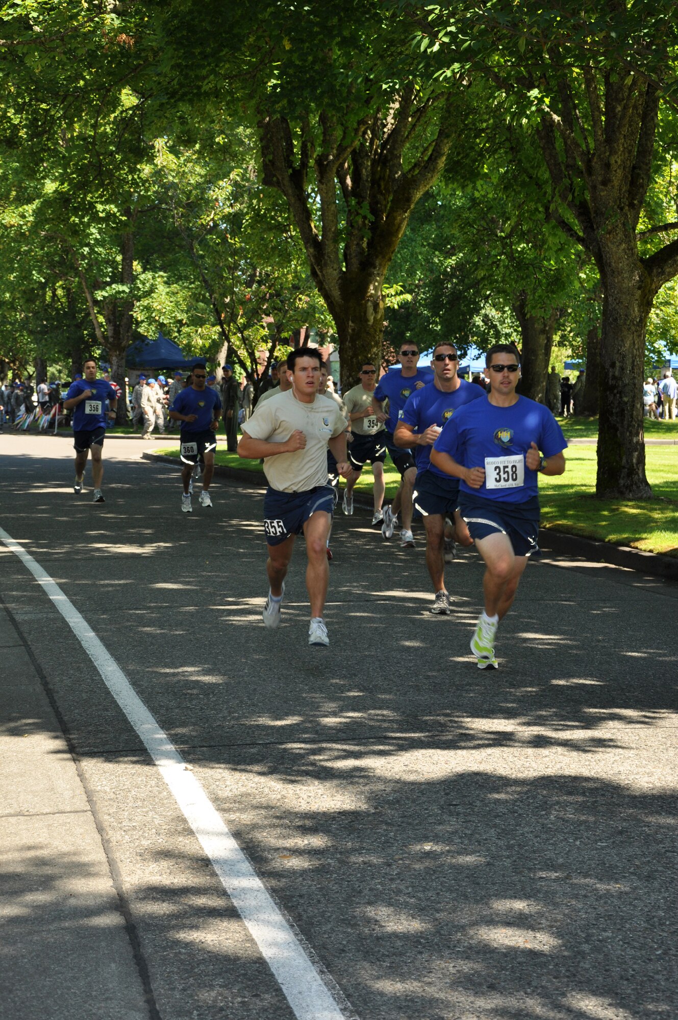 Fairchild Airmen competed in the Air Force fitness test against other teams at the 2011 Air Mobility Rodeo. The Fairchild team, pictured in tan T-shirts, weave through the pack during the first hundred meters of the 1.5 mile run July 24 following opening ceremonies. Senior Airman Alexander Aun, 92nd Security Forces Squadron, is leading the Fairchild runners at the start. Lt. Col. Brad Hamby, 92nd Air Refueling Squadron, finished first amongst the Fairchild team. (U.S. Air Force Photo/Tech. Sgt. Jennifer Buzanowski)