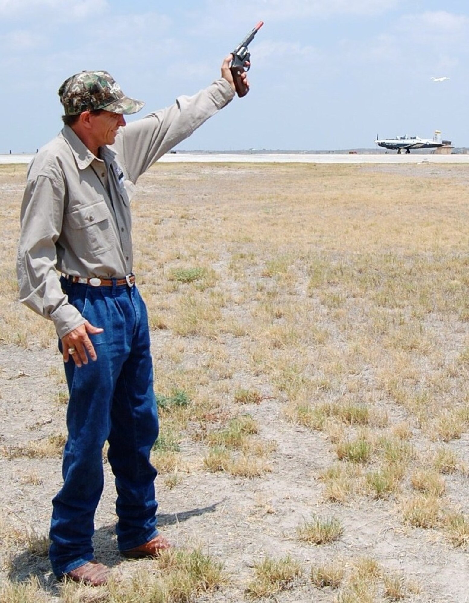 LAUGHLIN AIR FORCE BASE, Texas-- Dedrick “Bird Dog” Pesek, 47th Flying Training Wing Flight Safety wildlife biologist, scares birds away from Laughlin’s flight line July 22. For the past eight years, Bird Dog has been keeping the flight line safe from wildlife hazards. (U.S. Air Force photo by Laura Salazar)