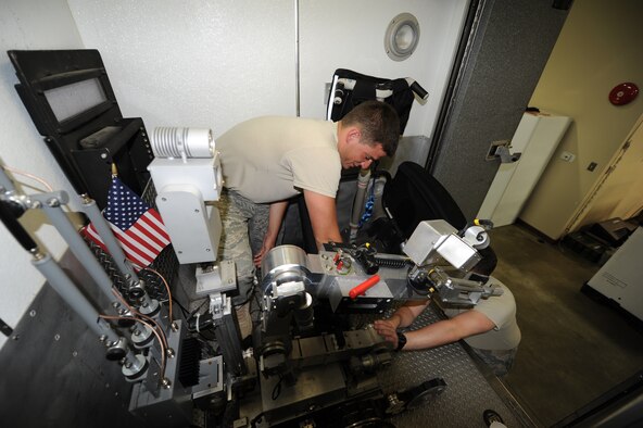 SEYMOUR JOHNSON AIR FORCE BASE, N.C. - Airman 1st Class Justin Beasley, 4th Civil Engineer Squadron explosive ordnance disposal apprentice, and Staff Sgt. Justin Walter, 4th CES EOD craftsman, inspect their bomb disposal robot July 26, 2011. The robot is used to diffuse and detect explosive devices, which protects the EOD personnel. Beasley hails from Wilmington and Walters hails from Greenville, Tenn. (U.S. Air Force photo/Senior Airman Gino Reyes)(Released)
