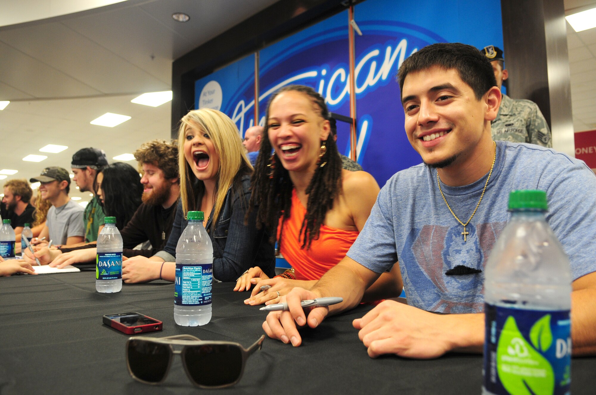 Several members of the American Idols road tour appear to enjoy interacting with some of the more than 2,000 military members and their families while visiting Tinker Air Force Base July 19.  Eleven members of the 2011 American Idols tour participated in the visit coordinated by the Air Force Reserve Recruiting Service's "Get One Now" program.  Those attending received autographed photos and had their pictures taken with their favorite entertainer.

