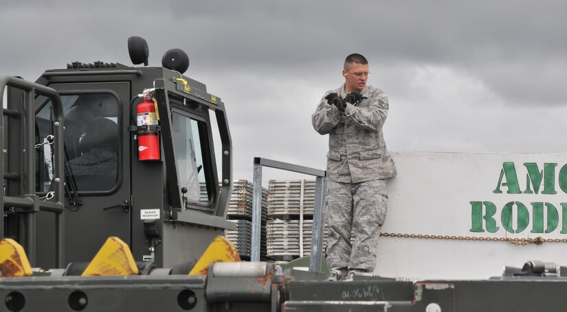 An Airman signals  stop to the driver of a Halvorsen loader, July 26, 2011, at Joint Base Lewis-McChord, Wash., during a 25K loader driving course. The event was part of Air Mobility Rodeo 2011, a biennial international competition that focuses on mission readiness, featuring airdrops, aerial refueling and other events that showcase the skills of mobility crews from around the world. (U.S. Air Force photo/Airman 1st Class Jared Trimarchi) 
