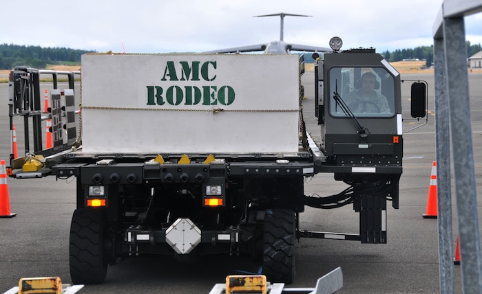 A driver raises a Halvorsen loader, July 26, 2011, at Joint Base Lewis-McChord, Wash., during a 25K loader driving course. The event was part of Air Mobility Rodeo 2011, a biennial international competition that focuses on mission readiness, featuring airdrops, aerial refueling and other events that showcase the skills of mobility crews from around the world. (U.S. Air Force photo/Airman 1st Class Jared Trimarchi) 
