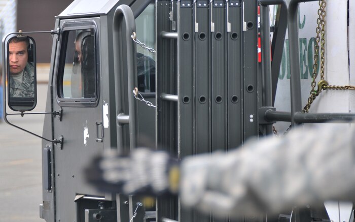 A driver relies on his spotter to back up a Halvorsen loader, July 26, 2011, at Joint Base Lewis-McChord, Wash., during a 25K loader driving course. The event was part of Air Mobility Rodeo 2011, a biennial international competition that focuses on mission readiness, featuring airdrops, aerial refueling and other events that showcase the skills of mobility crews from around the world. (U.S. Air Force photo/Airman 1st Class Jared Trimarchi) 
