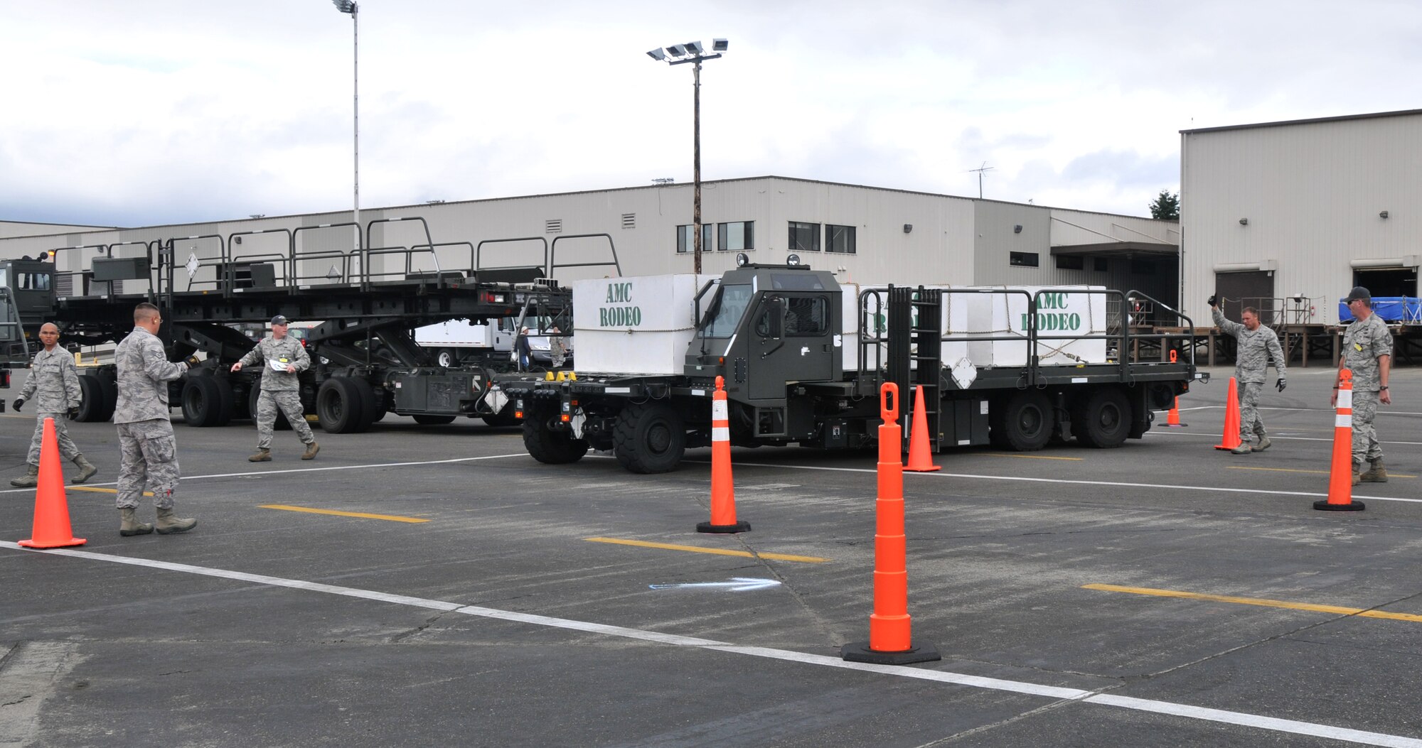 A five-man team competes in a 25K loader driving course, July 26, 2011, at Joint Base Lewis-McChord, Wash. The event was part of Air Mobility Rodeo 2011, a biennial international competition that focuses on mission readiness, featuring airdrops, aerial refueling and other events that showcase the skills of mobility crews from around the world. (U.S. Air Force photo/Airman 1st Class Jared Trimarchi) 

