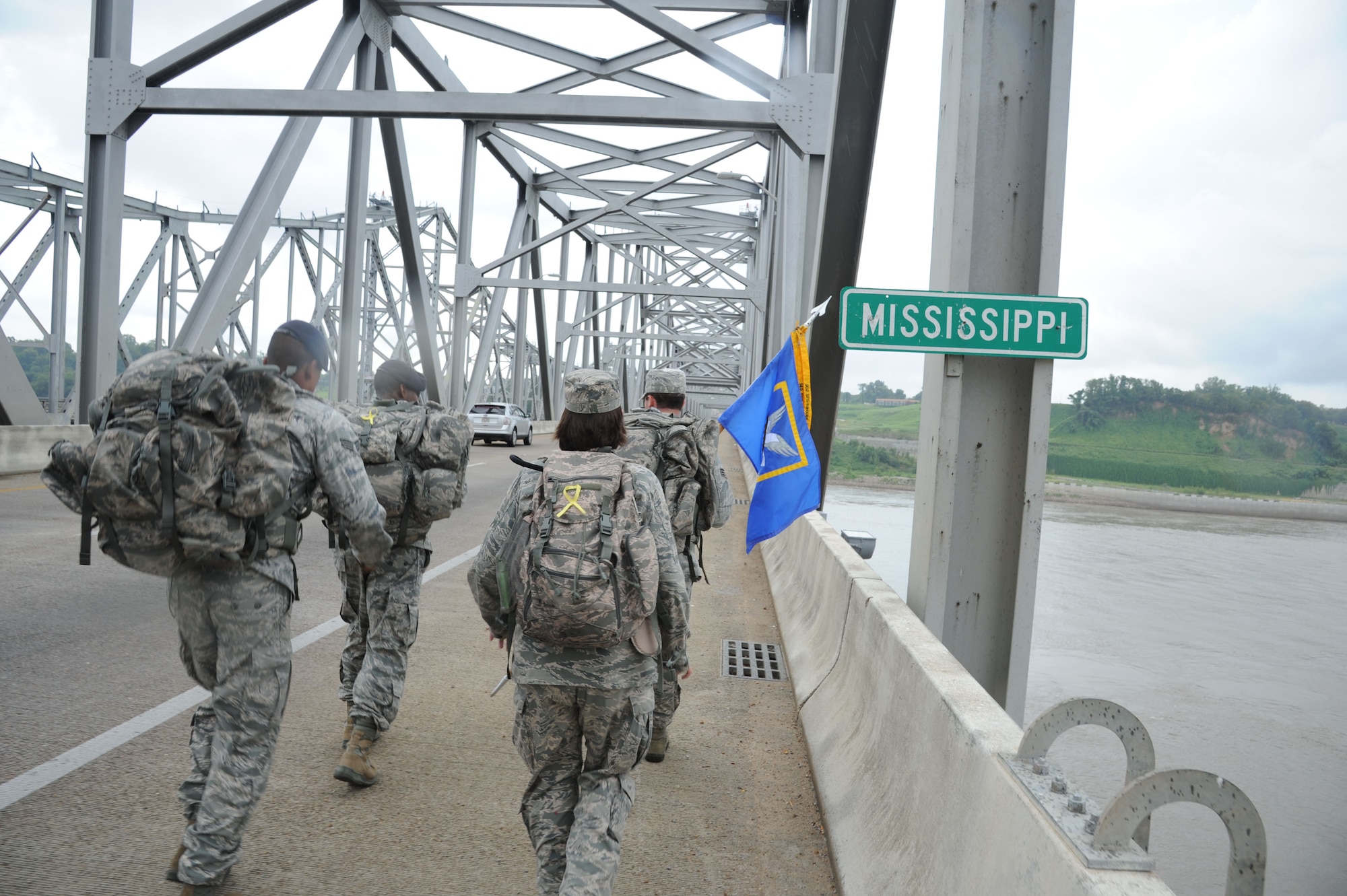 Four members of the 14th Security Forces Squadron from Columbus Air Force Base, Miss., carry the “Ruck March to Remember” guidon over the Mississippi state line on the Vidalia-Natchez Bridge on July 26. Team One marched 87 miles of the 146 mile leg assigned to the 14th SFS. (U.S. Air Force photo/Airman 1st Class Chase Hedrick)