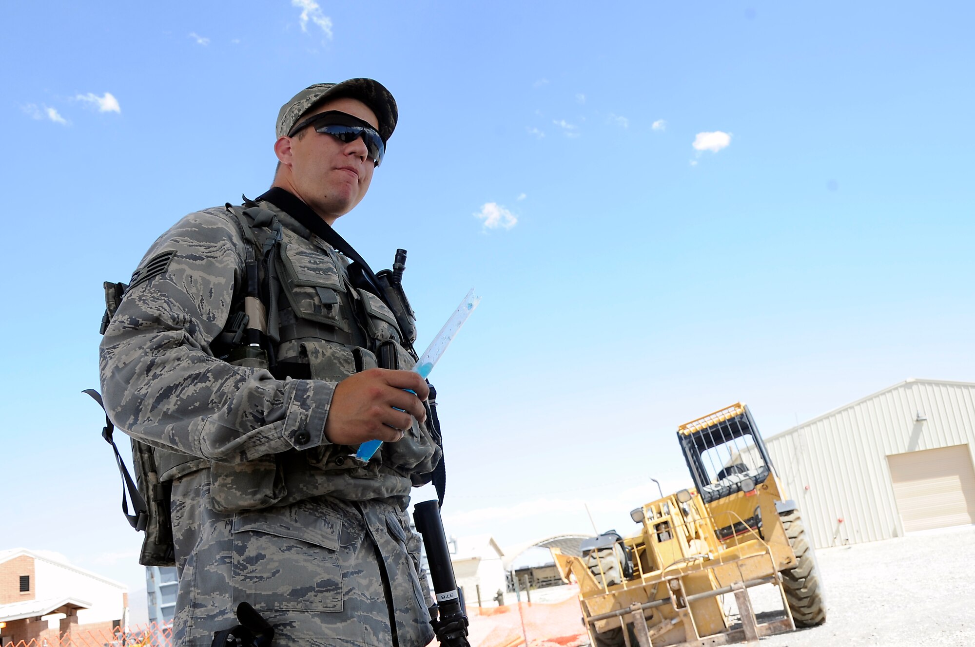 CREECH AIR FORCE BASE, Nev. -- U.S. Air Force Staff Sgt. Courtney Corral, 30th Security Forces Squadron member from Vandenberg Air Force Base, Calif., relaxes and takes a break in the shade July 19 at the 99th Ground Combat Training Squadron training range in the Nevada desert. Chaplains from the 432d Wing/432d Air Expeditionary Wing spoke to the training group during a morale and welfare visit and handed out snacks and water to the Airmen. (Photo by 432d Wing/432d Air Expeditionary Wing Public Affairs/Released)