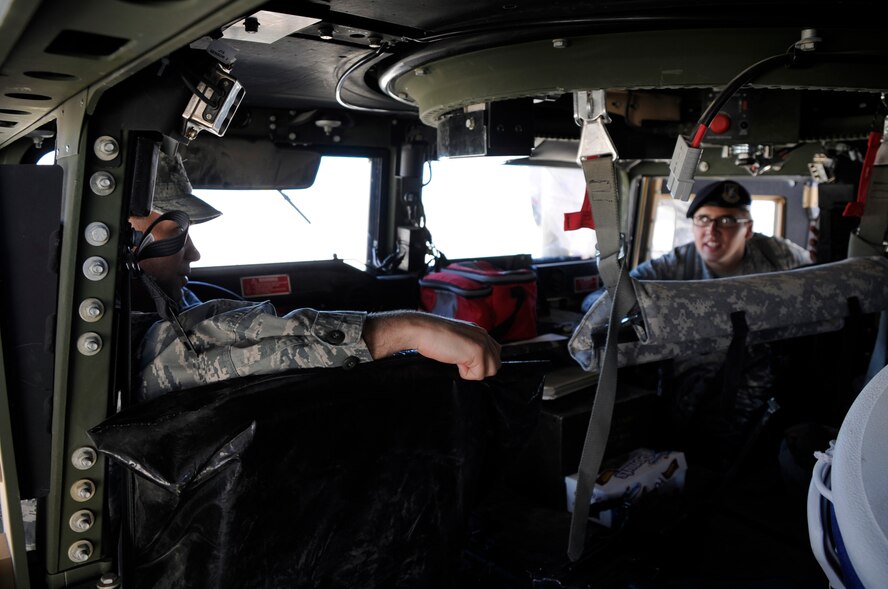 CREECH AIR FORCE BASE, Nev. -- A U.S. Air Force chaplain with the 432d Wing/432d Air Expeditionary Wing leans his head into a HUMVEE July 19 at Creech Air Force Base, Nev., to see the operational characteristics of the armored vehicle. An Airman from the 99th Security Forces Squadron spoke to him about its capabilities and how it provided mobility to SFS members. (Photo by 432d Wing/432d Air Expeditionary Wing Public Affairs/Released)