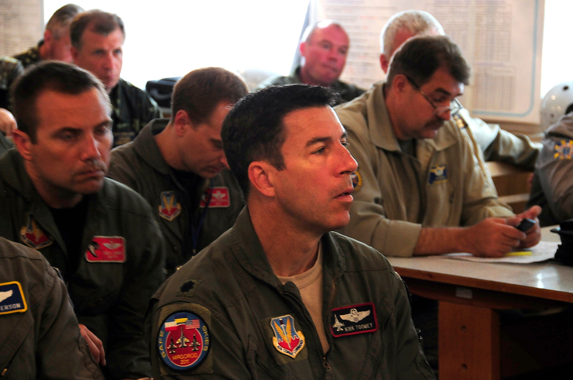 Lt. Col. Kirk Toomey of the California Air National Guard sits in a planning meeting before the launch of an intercept mission during SAFE SKIES 2011.  SAFE SKIES 2011 is a military-to-military exchange between airmen from the U.S., Ukraine and Poland to enhance airspace security over the Ukraine and Poland in preparation for EURO 2012, the European soccer championship games. (U. S. Air Force photo/Tech. Sgt. Charles Vaughn)
