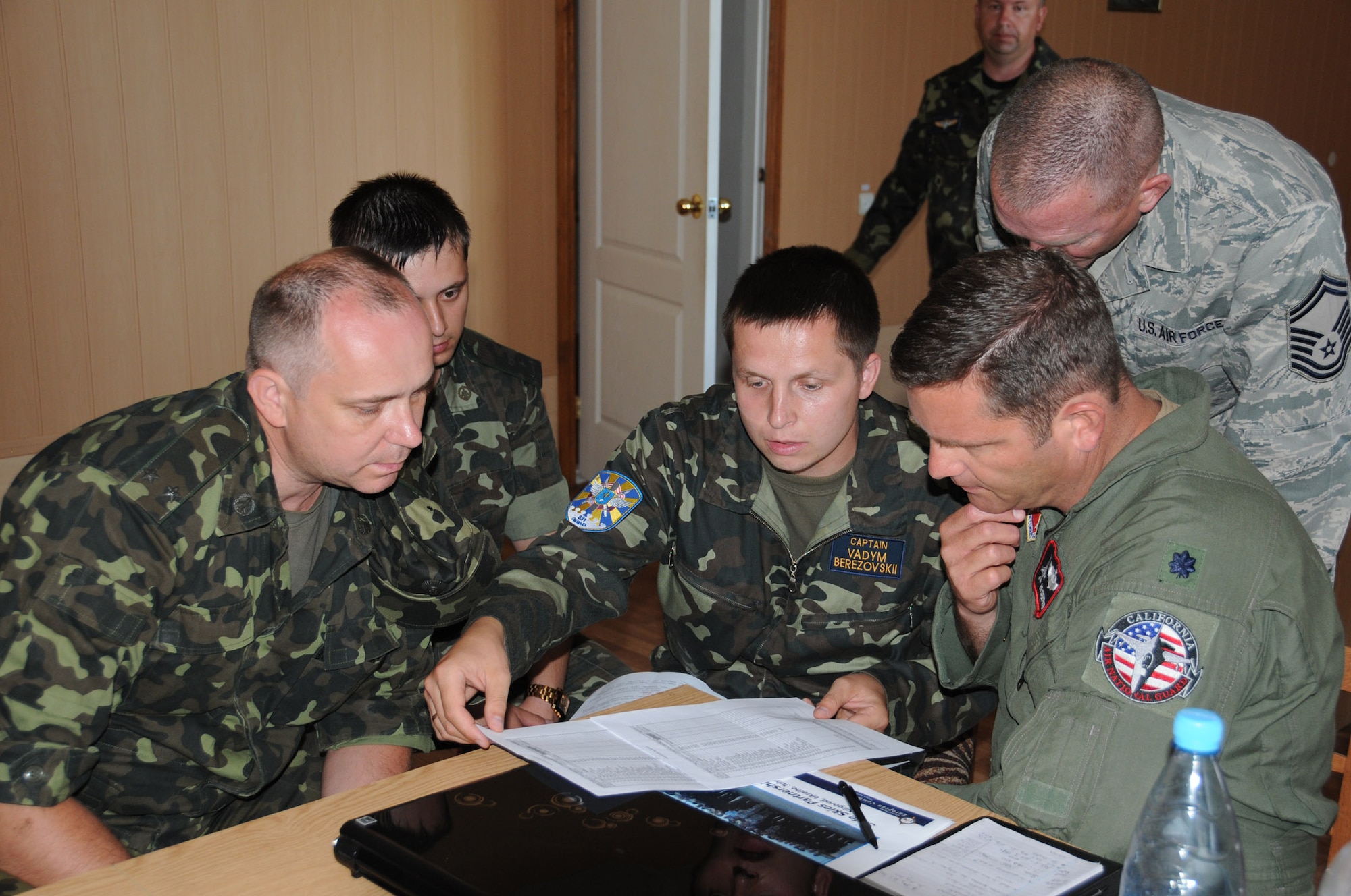 Lt. Col. Robert Swertfager, from the California Air National Guard’s 144th Fighter Wing in Fresno, discusses the itinerary for SAFE SKIES 2011 with his Ukrainian counterparts July 16, 2011.  SAFE SKIES 2011 is a military-to-military exchange between airmen from the U.S., Ukraine and Poland to enhance airspace security over the Ukraine and Poland in preparation for EURO 2012, the European soccer championship games. (U. S. Air Force photo/Tech. Sgt. Charles Vaughn)