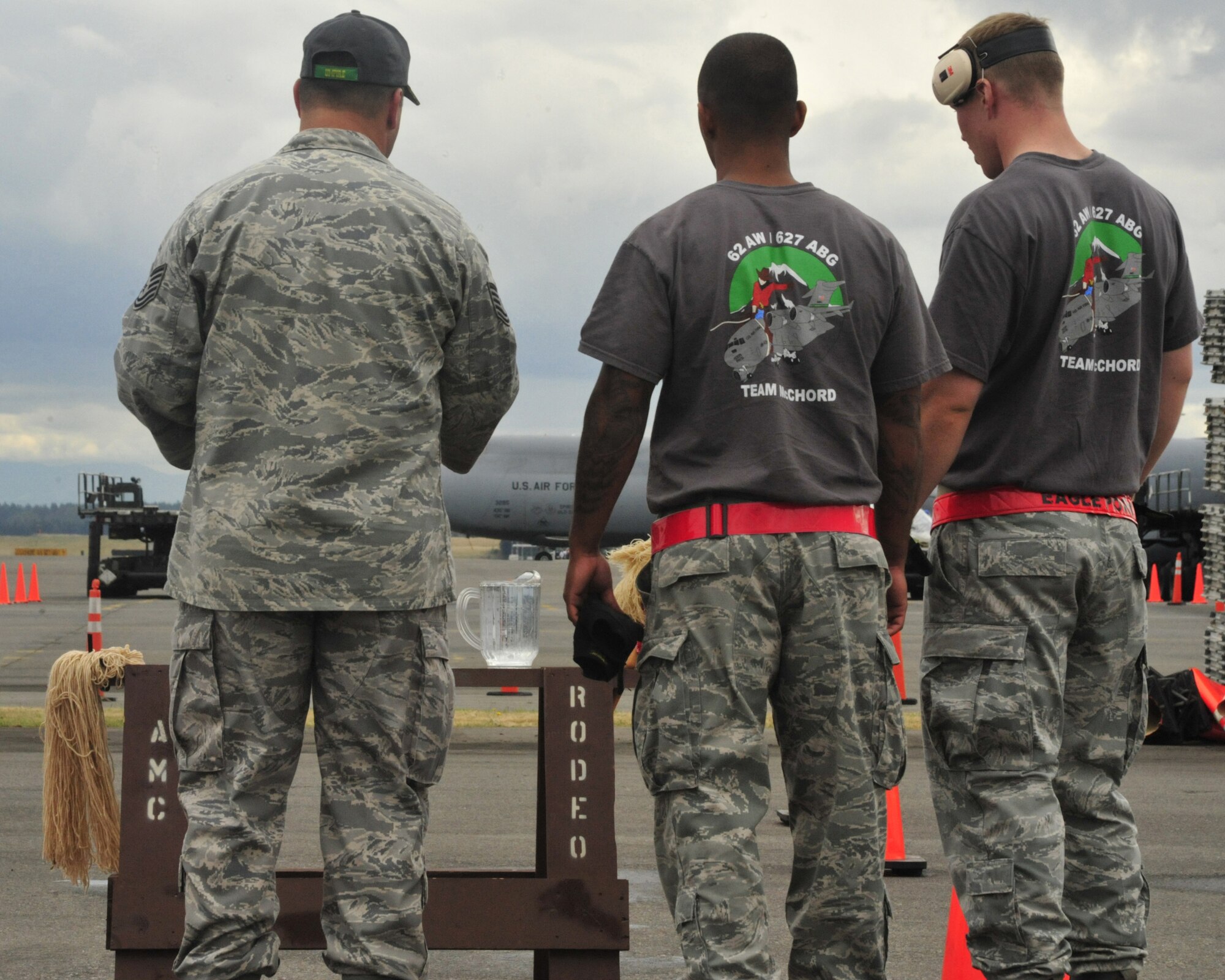 A Rodeo umpire informs Staff Sgts. Chris Lenane (right) and Christopher Johnson (middle), 62nd Aerial Port Squadron Rodeo team members, of the rules prior to the start of the 10K forklift obstacle course competition July 25, 2011, during Air Mobility Rodeo 2011 at Joint Base Lewis-McChord, Wash. Competitors were required to transport a horse saw with a pitcher of water on top through the obstacle course and points were deducted for every inch of water spilled. (U.S. Air Force Photo/Staff Sgt. Frances Kriss) 