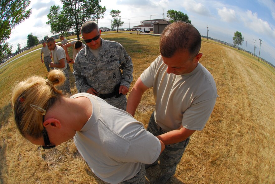 Led by Master Sgt Marvin DiPilato, 914th Security Forces training manager, Airmen from the 914th Security Forces Squadron instructs security forces augmentees on handcuffing techniques during the 914th Airlift Wing Unit Training Assembly July 22, 2011 Niagara Falls Air Reserve Station NY. The augmentees assist Military Law Enforcement with many aspects of base security. 