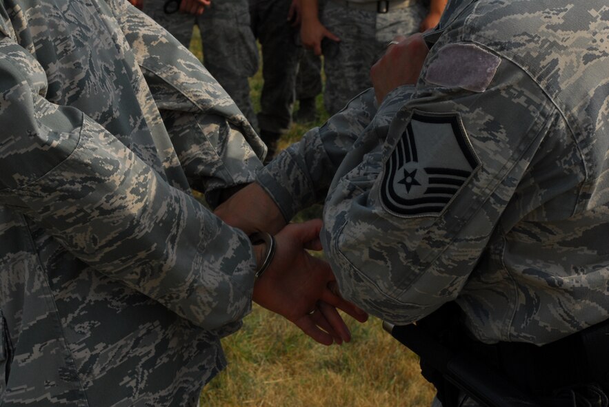 Led by Master Sgt Marvin DiPilato, 914th Security Forces training manager, Airmen from the 914th Security Forces Squadron instructs security forces augmentees on handcuffing techniques during the 914th Airlift Wing Unit Training Assembly July 22, 2011 Niagara Falls Air Reserve Station NY. The augmentees assist Military Law Enforcement with many aspects of base security. 