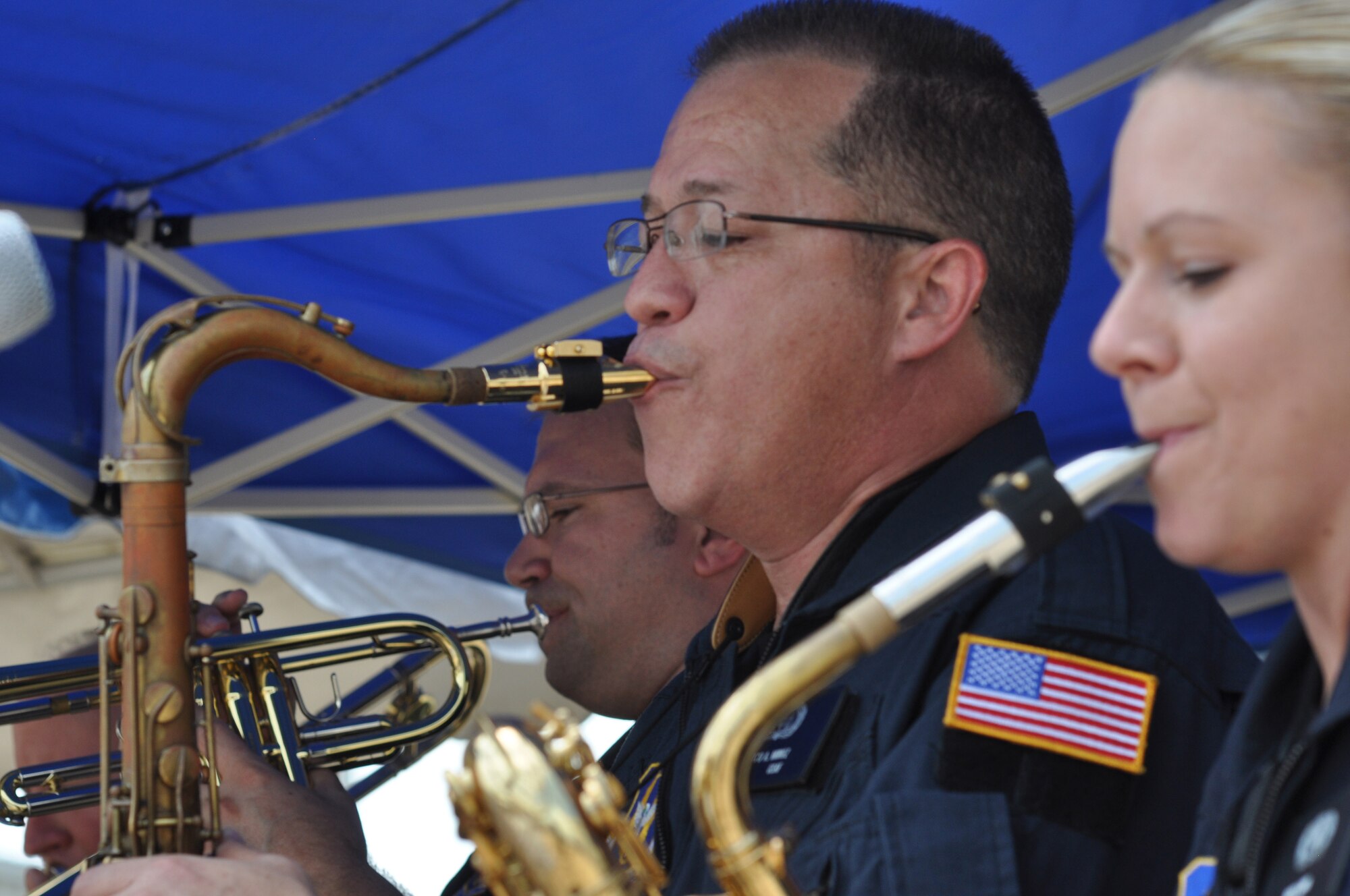 Staff Sgt. Dave Kness, Staff Sgt. Marco Munoz, and Airman 1st Class Mary
Gant, members of the Band of the U.S. Air Force Reserve's High Flight,
performed before 3,300 spectators after the final landing of Shuttle
Atlantis July 21 at the Kennedy Space Center in Florida. The event
celebrated the 135th shuttle mission and 30 years of NASA's space shuttle
program. High Flight, the newest ensemble in the Reserve band, is a 10-piece
funk and Rhythm and Blues music group. This ensemble provides a fresh
perspective on today's popular music and preserves the classic sounds of
bands like Chicago, Tower of Power, and Earth, Wind, and Fire. (U.S. Air Force photo/Candice Allen)
