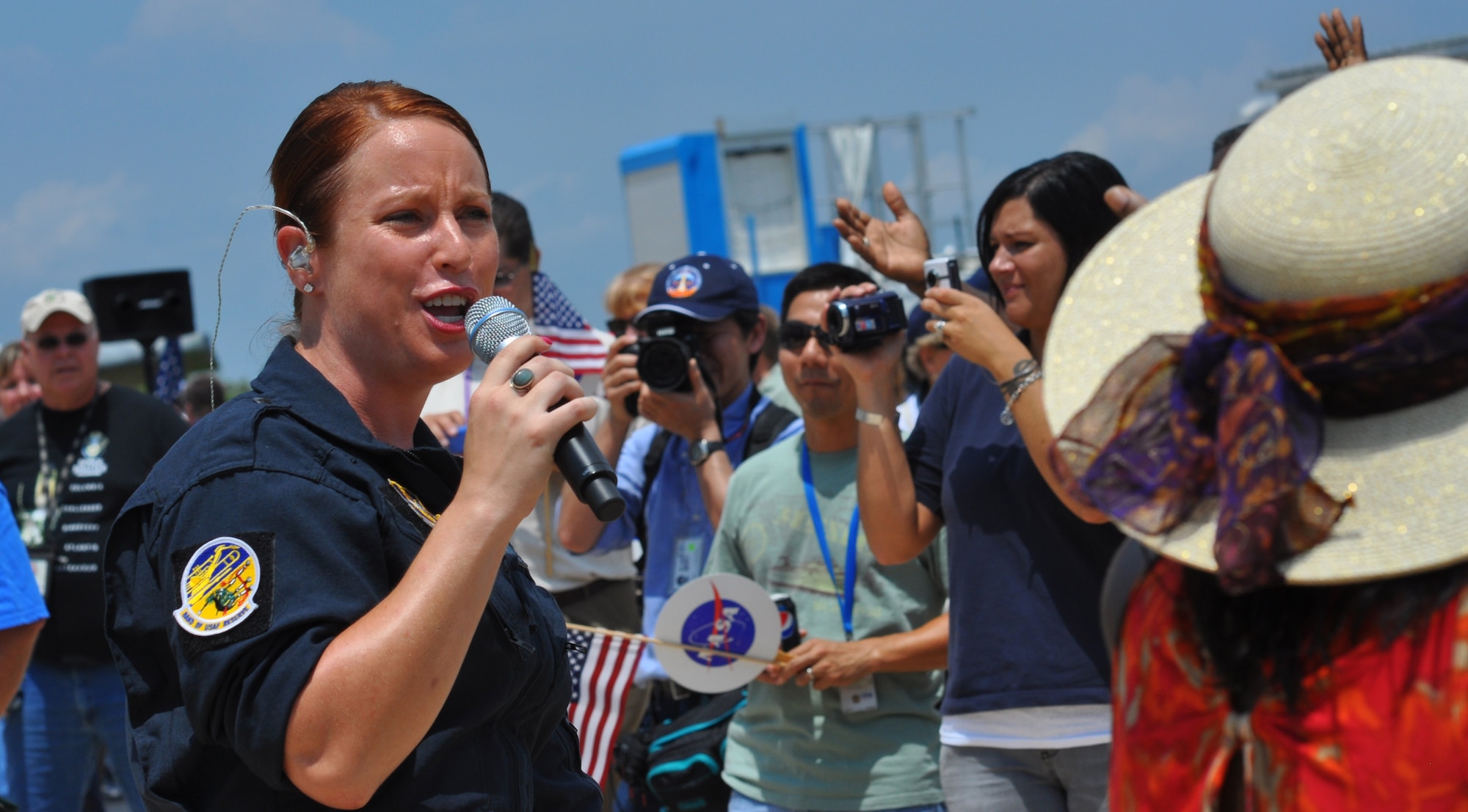 Airman 1st Class Jill Diem, a vocalist with the Band of the U.S. Air Force
Reserve's High Flight, belts out tunes before 3,300 NASA employees at the
Kennedy Space Center in Florida, July 21. The event culminated NASA's
30-year space shuttle program.  (U.S. Air Force photo/Candice Allen)
