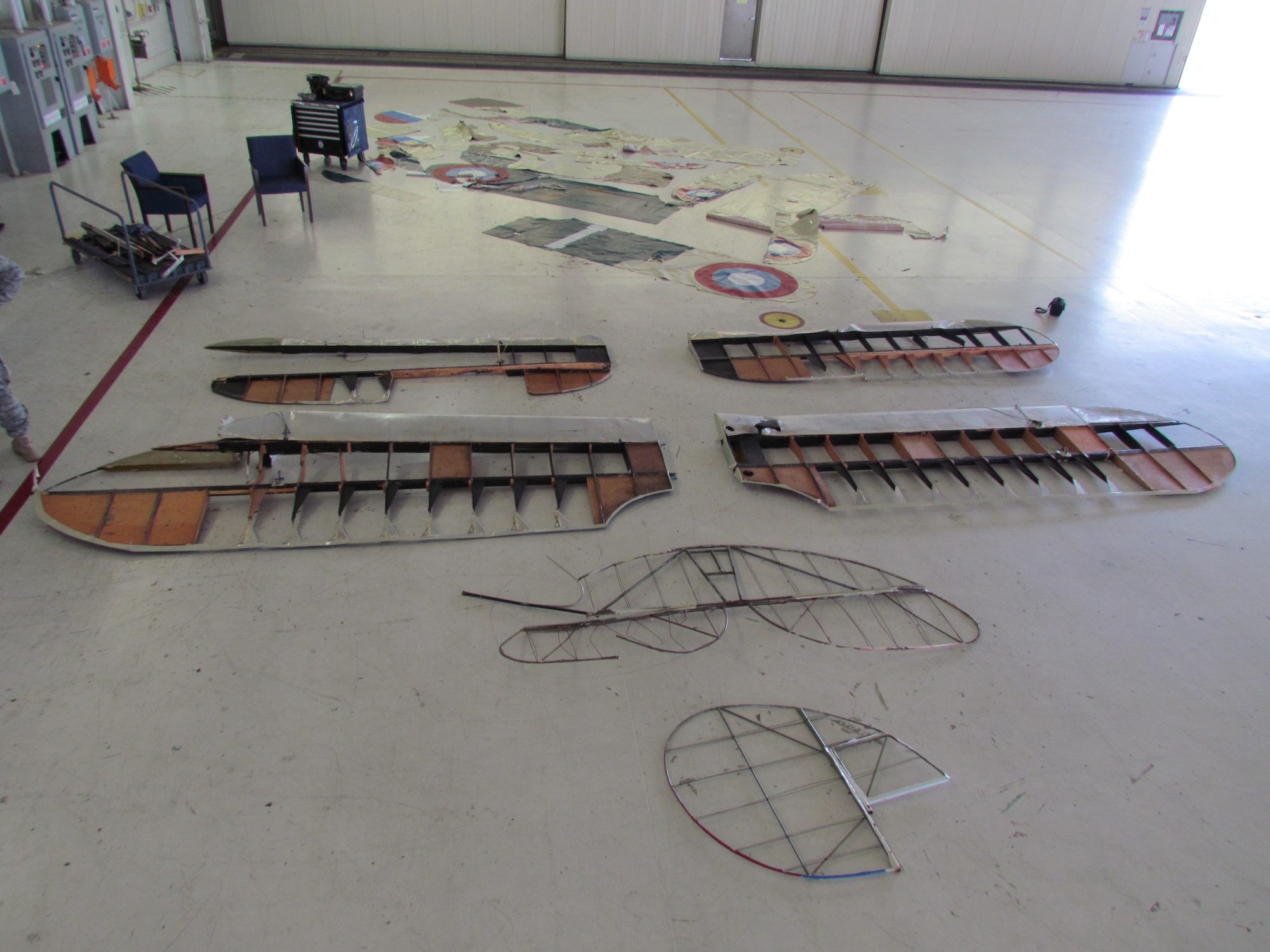 Pieces of the 94th Aircraft Maintenance Unit's Nieuport 28 replica are laid out before it is repaired at Langley Air Force Base, Va. The plane was destroyed during a storm May 24. (Courtesy Photo)