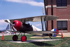 The 94th Aircraft Maintenance Unit's Nieuport 28 replica is displayed on the side of the building at Langley Air Force Base, Va. The aircraft was one of the first flown by the 94th Aero Squadron in 1917. (Courtesy Photo)