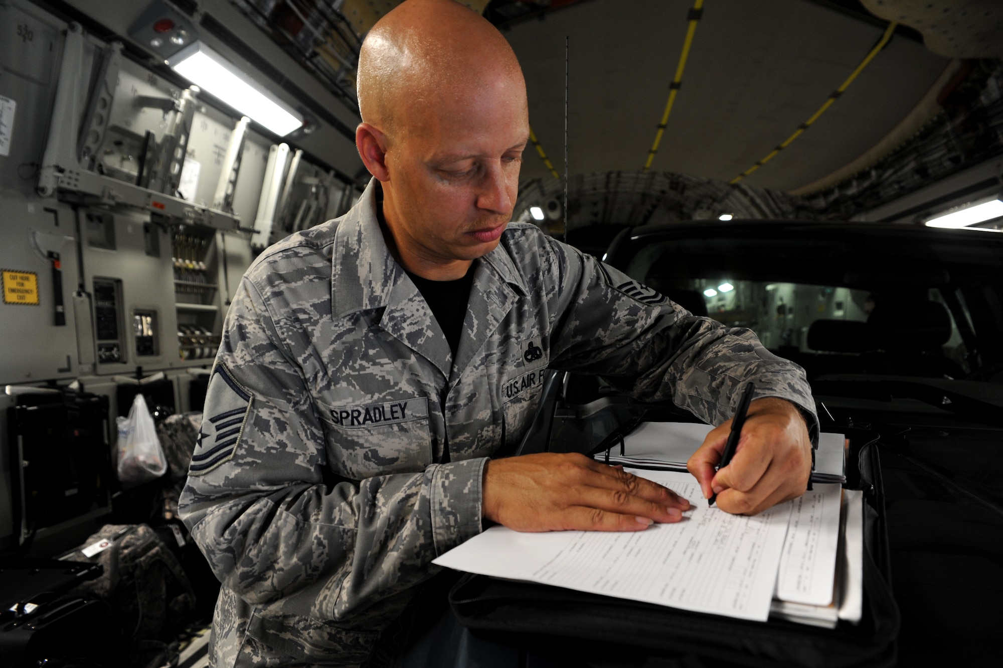 Master Sgt. Terrence Spradley signs the discrepency form in black ink signifiying the C-17 aircraft he and his team worked on for Rodeo 2011 had zero discrepencies. Spradly is the 437th Maintenance Group superintendent.