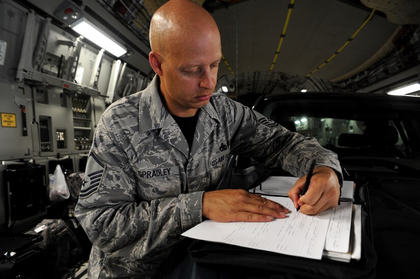 Master Sgt. Terrence Spradley signs the discrepency form in black ink signifiying the C-17 aircraft he and his team worked on for Rodeo 2011 had zero discrepencies. Spradly is the 437th Maintenance Group superintendent.