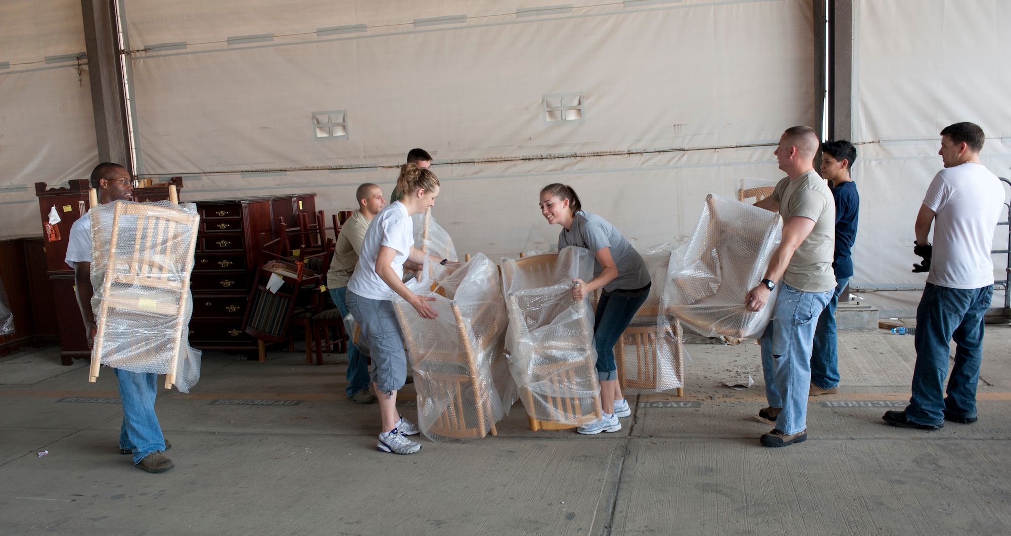 Volunteers from the 39th Air Base Wing prepare furniture for shipment in the Defense Logistics Agency Disposition Services warehouse July 25, 2011, at Incirlik Air Base Turkey. The furniture was issued to the U.S. State Department to be donated to an outpatient clinic in the Republic of Georgia and a school in Azerbaijan. (U.S. Air Force photo by Airman 1st Class Clayton Lenhardt/Released)
