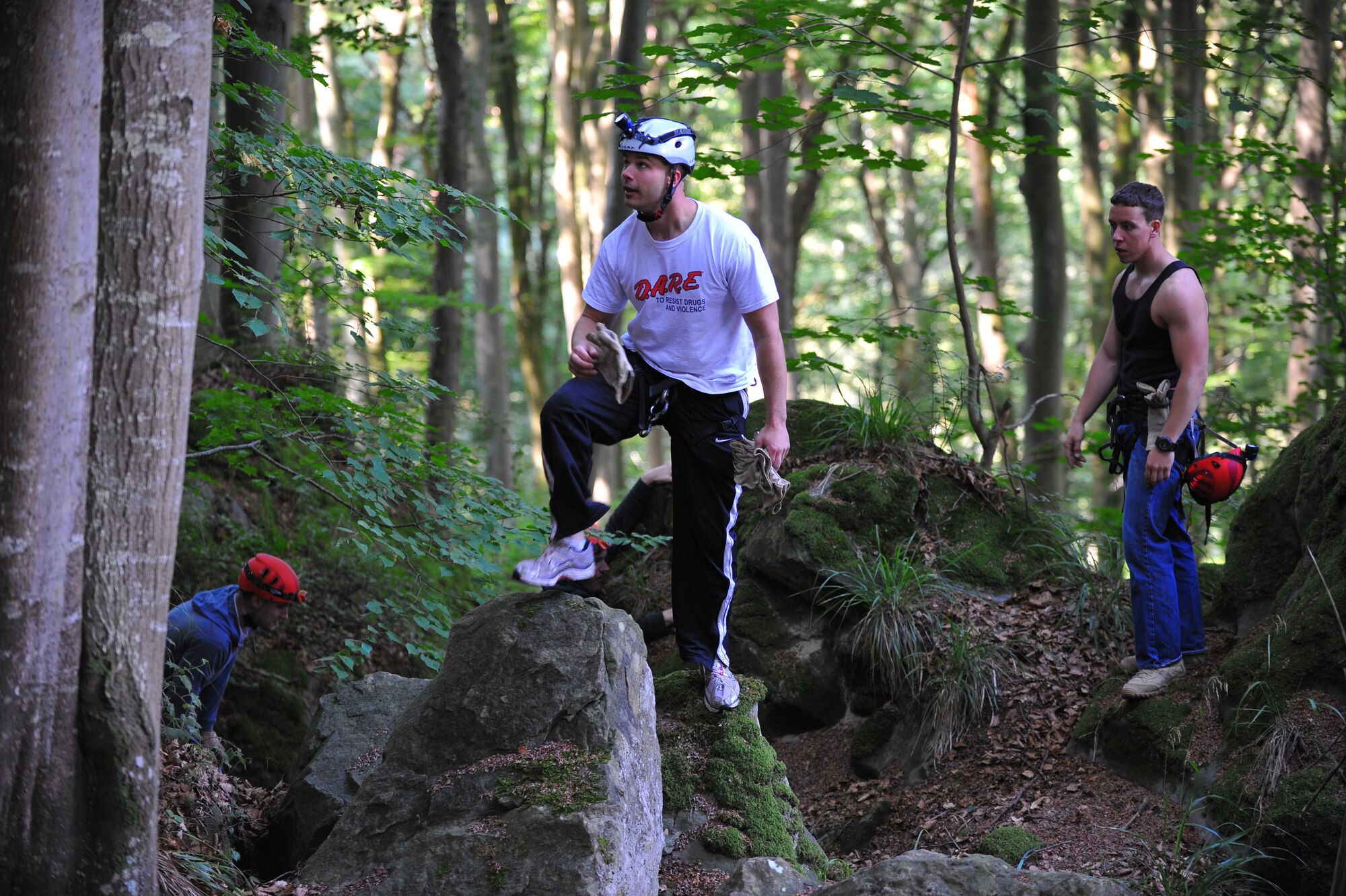 ECHTERNACH, Luxembourg – Airman 1st Class Richard Moore, left, 52nd Communications Squadron, Senior Airman Christopher Chesnek, center, 52nd CS, and Airman 1st Class Jonathan Martin, 52nd Logistics Readiness Squadron, hike up a mountain during a caving and rappelling trip here July 23. Spangdahlem Outdoor Recreation offers caving and rappelling trips annually from April to August for people of all skill levels. (U.S Air Force photo/Airman 1st Class Dillon Davis)