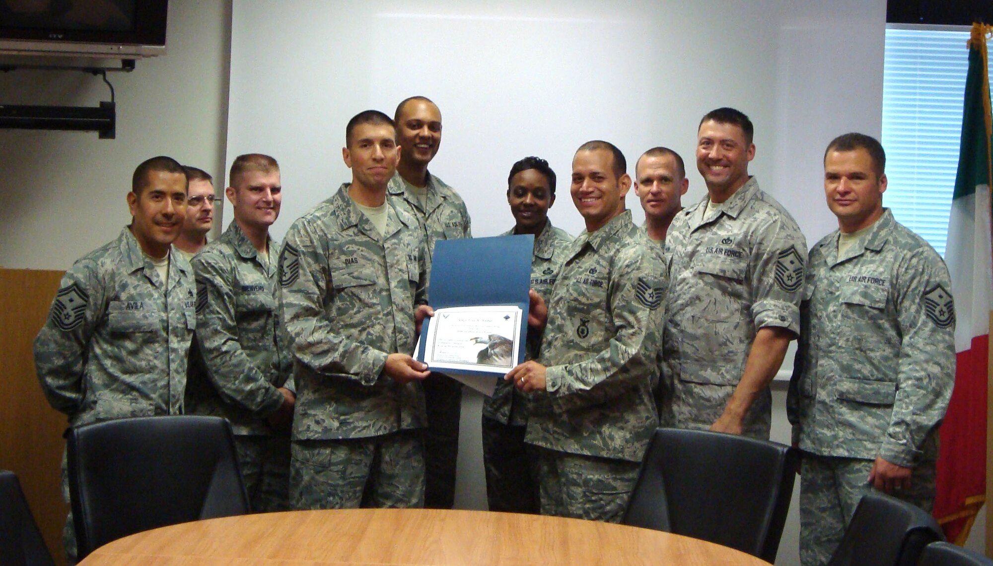 Tech. Sgt. Jose Nadal, 31st Security Forces Squadron personnel reliability program monitor, is presented the Diamond Sharp award for May by the Aviano First Sergeants Council. The Diamond Sharp award is designed to recognize Aviano Airmen who distinguish themselves through outstanding professionalism, impeccable appearance and a "can do" attitude. (Courtesy photo)