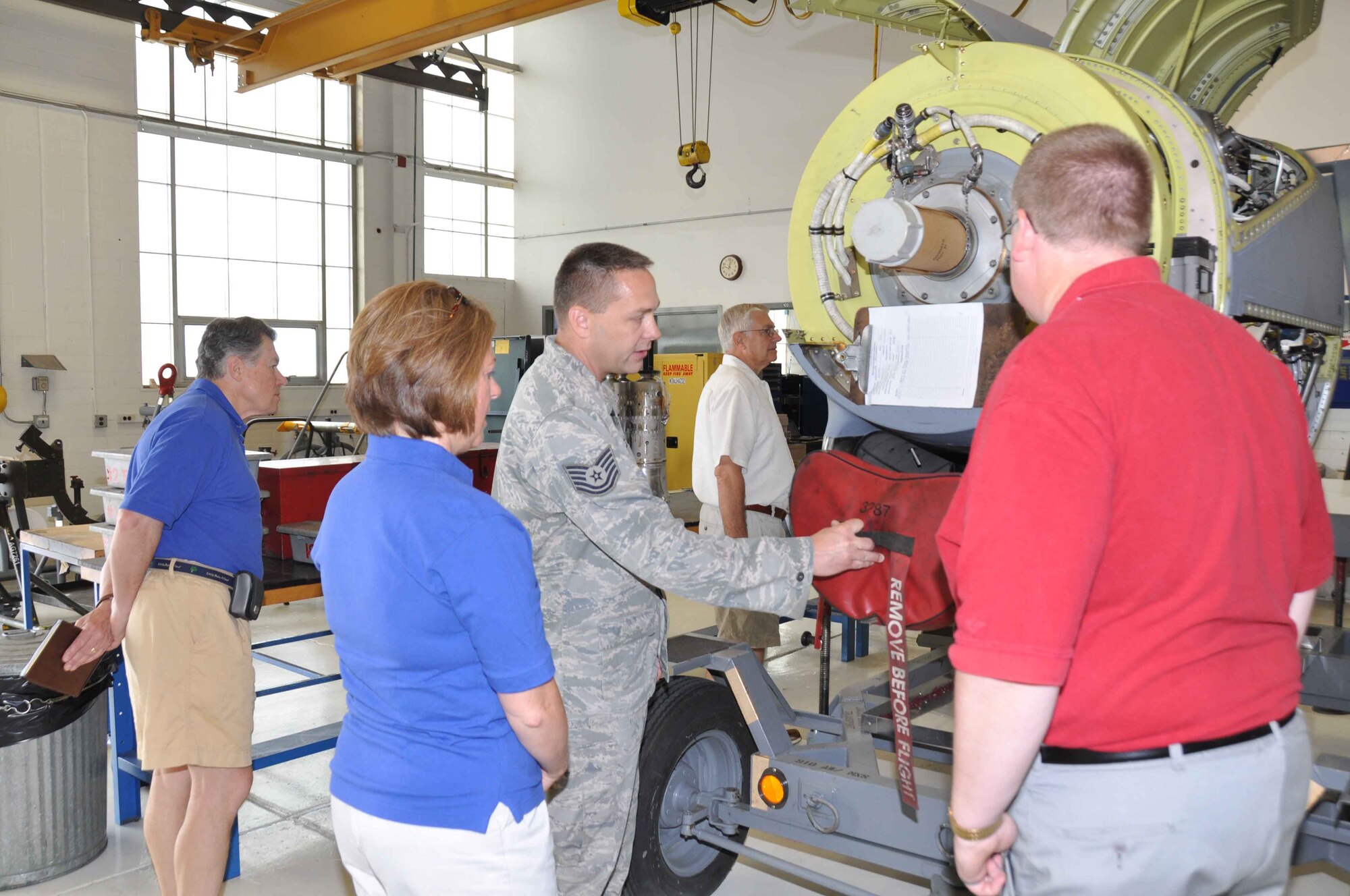 Tech. Sgt. Chris Hanson talks about the C-130 engine during the Base Community Council tour July 22. (Air Force Photo/Paul Zadach)