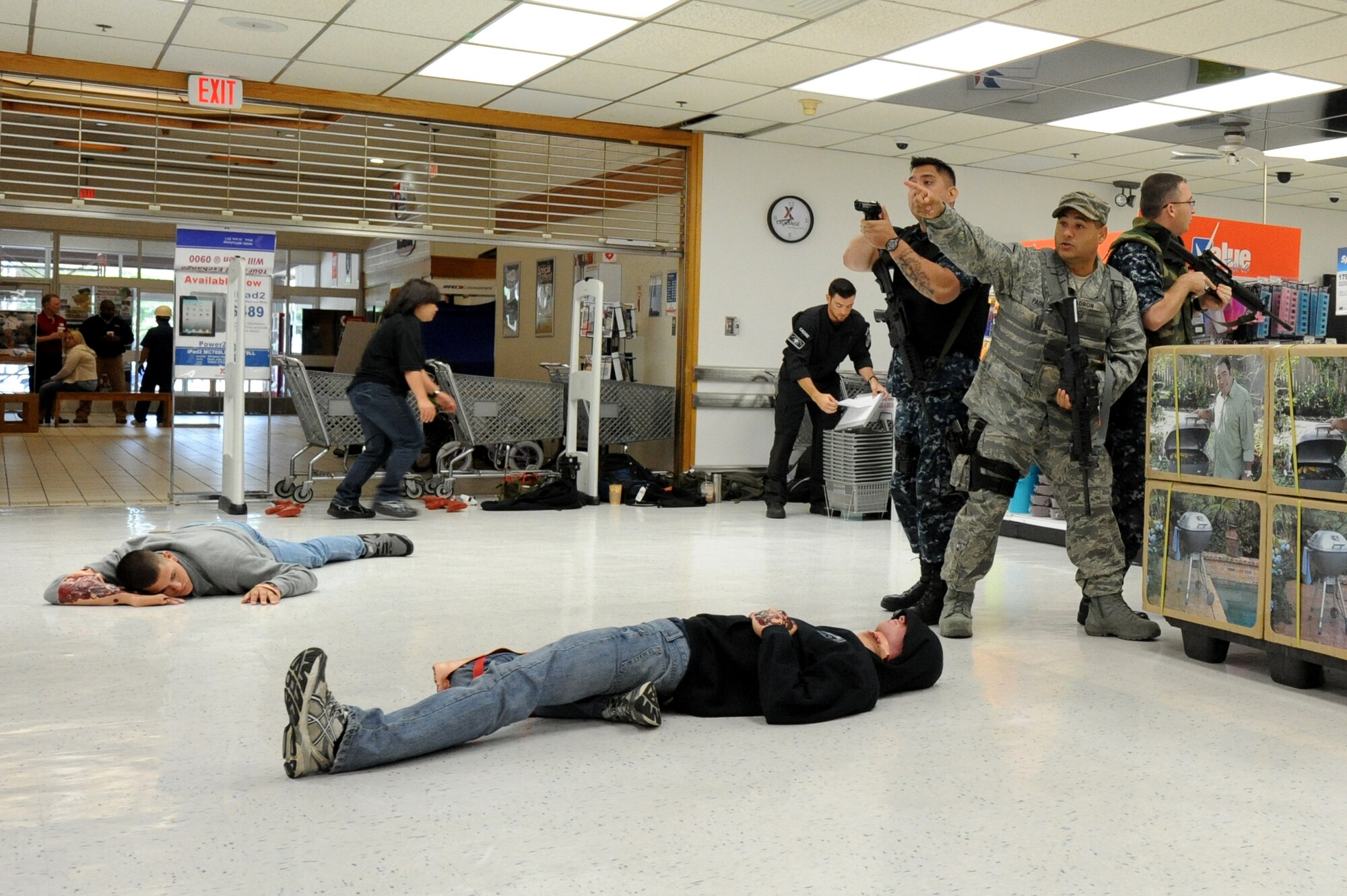 MISAWA AIR BASE, Japan -- Members of the 35th Security Forces Squadron team up with the Naval Air Facility Security Department to take down an active shooter during a High Risk Response Training course held at the Base Exchange 22 July.  The HRRT course was conducted by the Pacific Air Force's Mobile Team and consists of a high-risk response program taught to base security members which allows them to respond and effectively handle an active shooter incident. (U.S. Air Force photo/Staff Sgt. April Quintanilla)