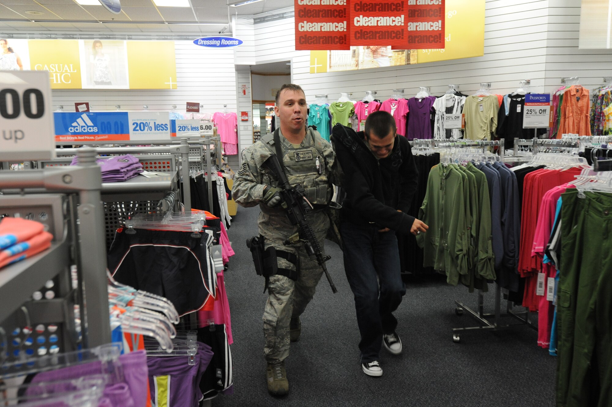 MISAWA AIR BASE, Japan -- Tech. Sgt. Jeremy Potts, left, 35th Security Forces Squadron, grabs a distraught individual and escorts him out of the Base Exchange during a High Risk Response training 22 July.  The HRRT course was conducted by the Pacific Air Force's Mobile Team and is an intensive five-day course based on real-life scenarios providing effective response tactics to empower Security Forces members to swiftly eliminate HRR threats.  (U.S. Air Force photo/Staff Sgt. April Quintanilla)
