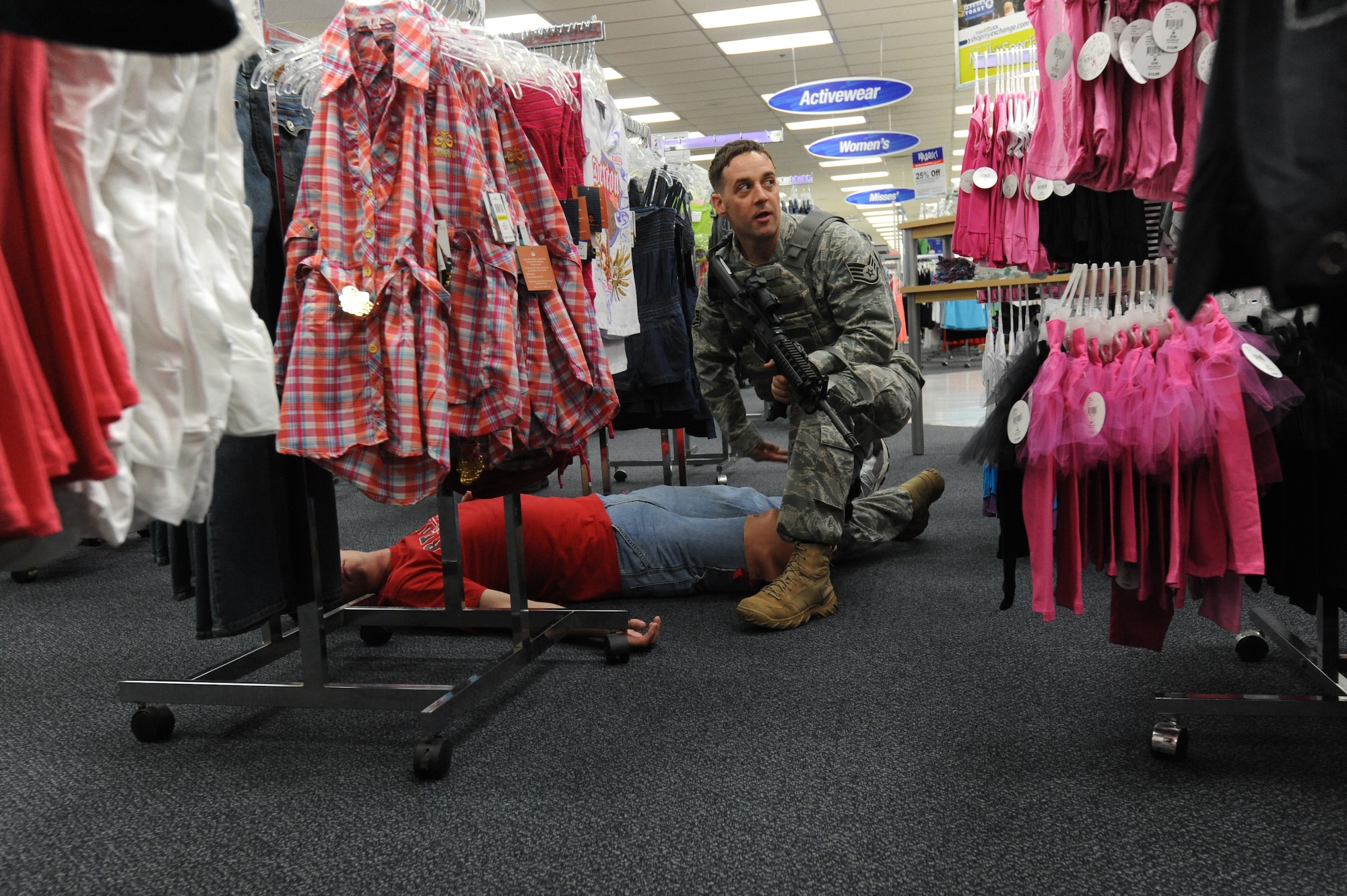 MISAWA AIR BASE, Japan -- Staff Sgt. Jonathan McQuay, kneeling, 35th Security Forces Squadron, checks for a response from a simulated victim during a High Risk Response training course held at the Base Exchange 22 July.  The HRRT course was conducted by the Pacific Air Force's Mobile Team and is an intensive five-day course based on real-life scenarios providing effective response tactics to empower Security Forces members to swiftly eliminate HRR threats. (U.S. Air Force photo/Staff Sgt. April Quintanilla)