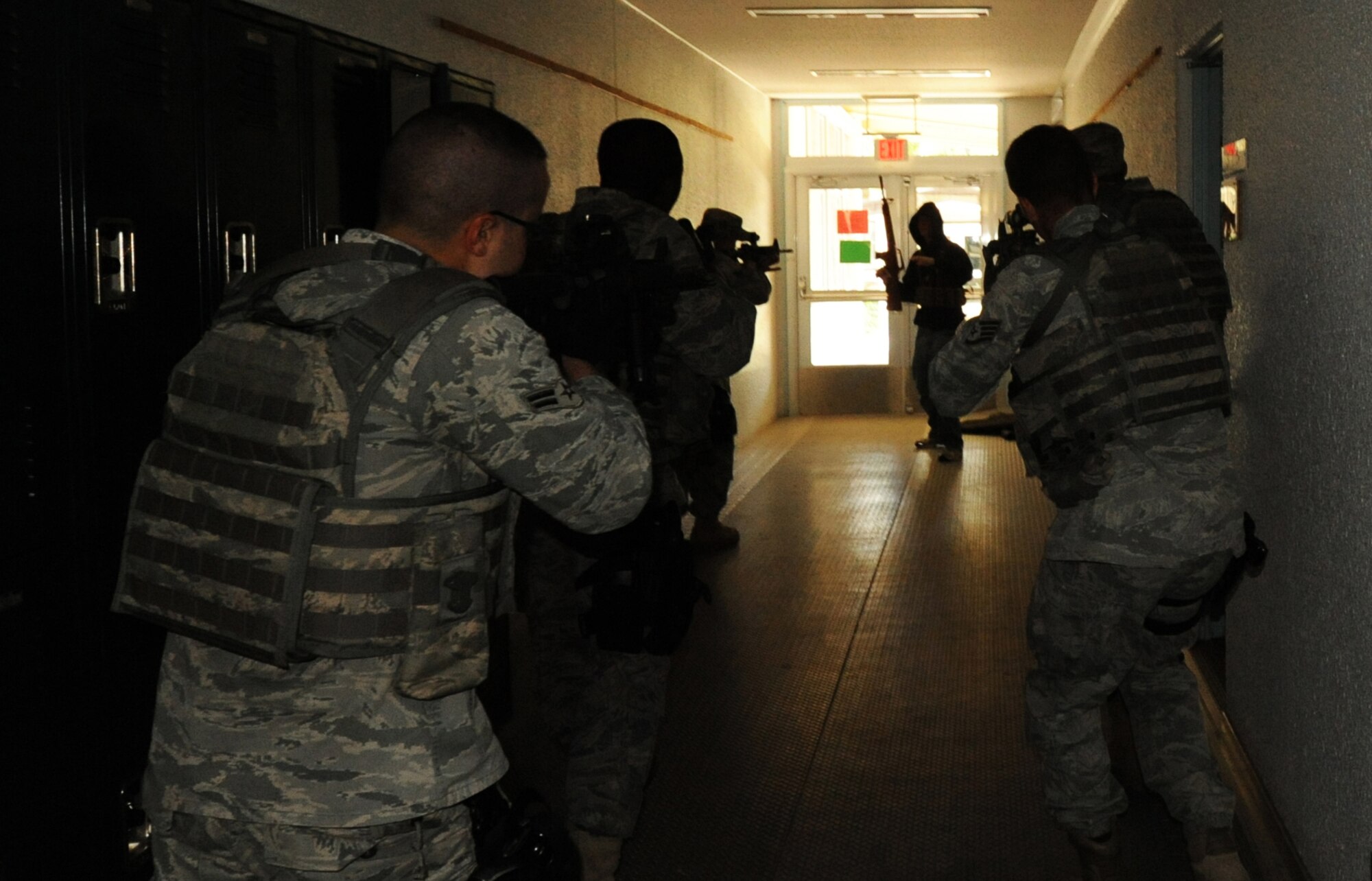 MISAWA AIR BASE, Japan -- Members of the 35th Security Forces Squadron team up with the Naval Air Facility Security Department to take down an active shooter during a High Risk Response training course held at Edgren High School 22 July.  The HRRT course was conducted by the Pacific Air Force's Mobile Team and is part of a high-risk response program taught to base security members which allows them to respond to an active shooter incident. (U.S. Air Force photo/Staff Sgt. April Quintanilla)