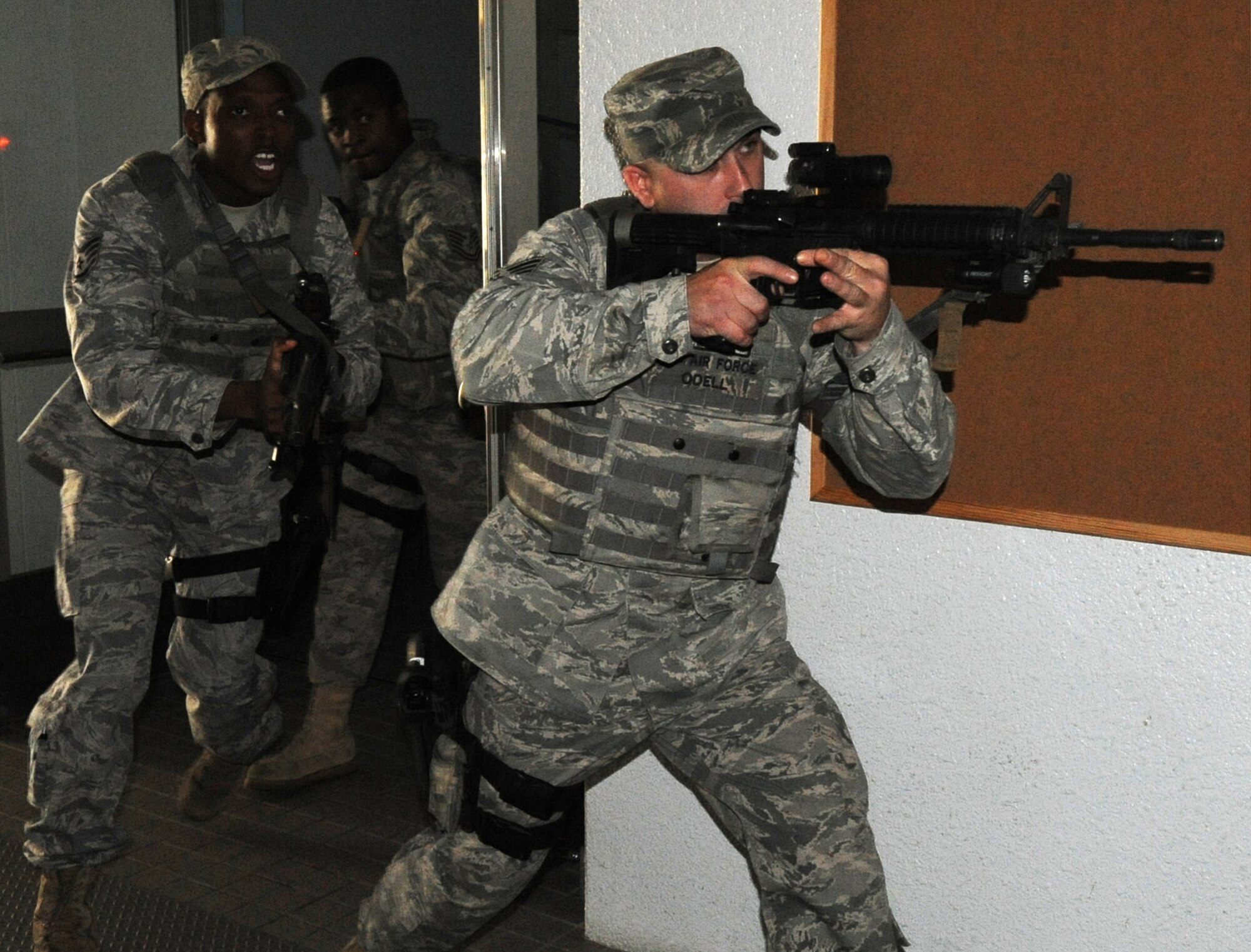 MISAWA AIR BASE, Japan -- Staff Sgt.'s Noah Odell, front, Jason Lilly, center, and Tech. Sgt. David Shaw, 35th Security Forces Squadron, respond to a simulated shooting at Edgren High School during a High Risk Response training course 22 July.  The HRRT course was conducted by the Pacific Air Force's Mobile Team and is part of a high-risk response program taught to base security members which allows them to respond and effectively handle an active shooter incident. (U.S. Air Force photo/Staff Sgt. April Quintanilla)