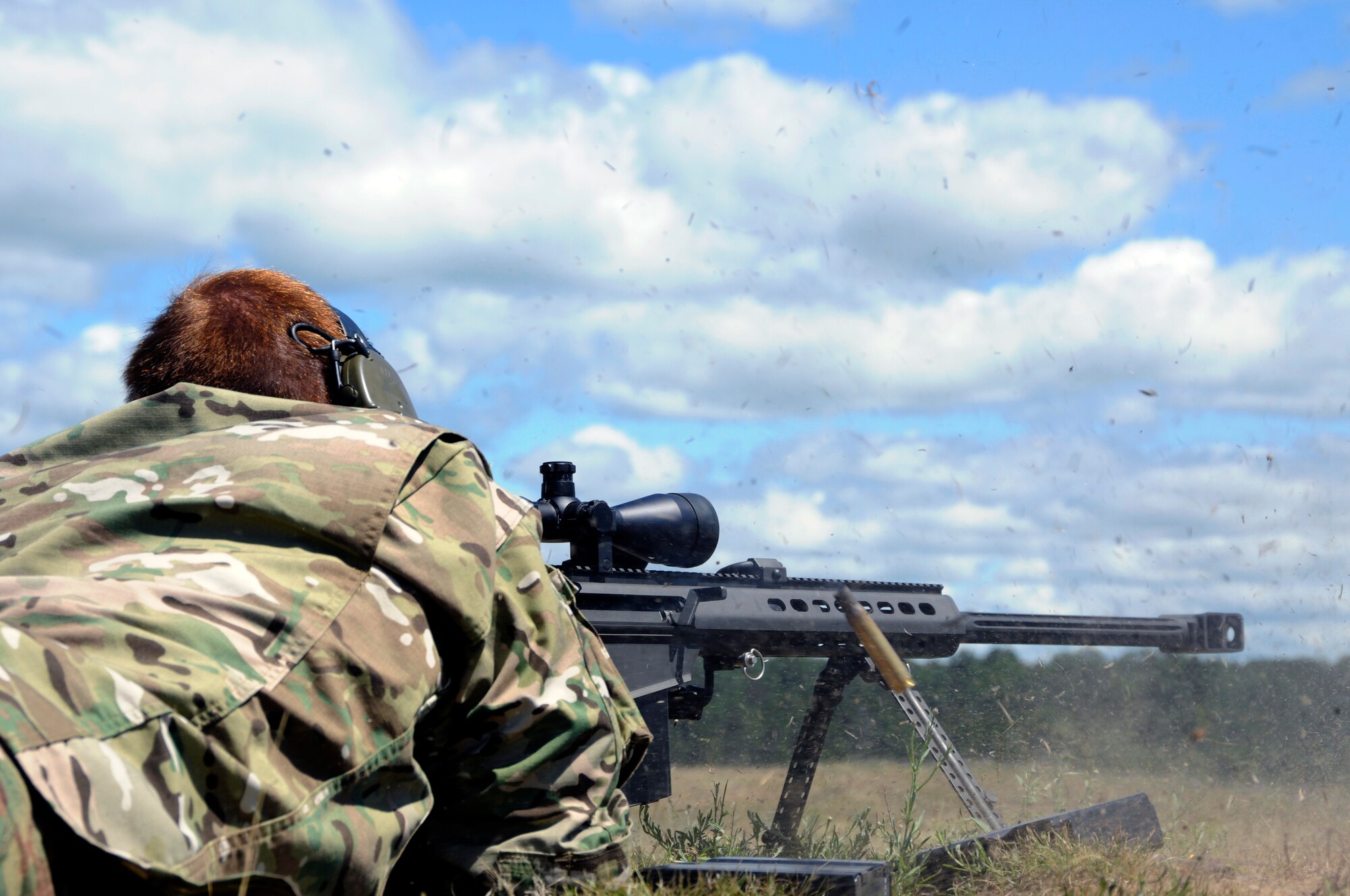 Master Sgt. Michael McGann from Selfridge Air National Guard Base, 107th Weather Flight, fires a round from the M107 Barrett sniper rifle at Camp Grayling Joint Maneuver Training Center, Mich., during the annual Grey Wolverine training exercise, July 26, 2011. In order to accomplish their mission as part of Air Force Special Operations Command, McGann and other members of the 107th Weather Flight, must be extremely knowledgeable and proficient with a wide variety of weapons and technical equipment.  (U.S. Air Force photo by TSgt. David Kujawa)