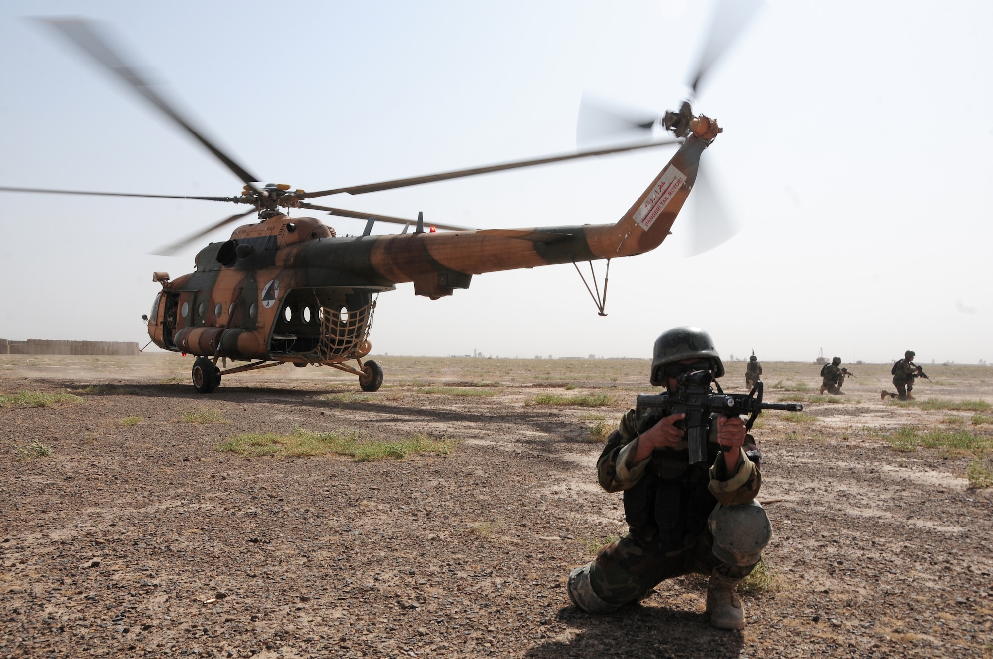 Afghan Special Forces members run off an Afghan Air Force Mi-17 helicopter during a training mission at Forward Operating Base Thomas, Shindand, Afghanistan July 19, 2011.  The training mission involved flying to locations and clearing buildings.  (U.S. Air Force photo by Senior Airman Amber Williams)