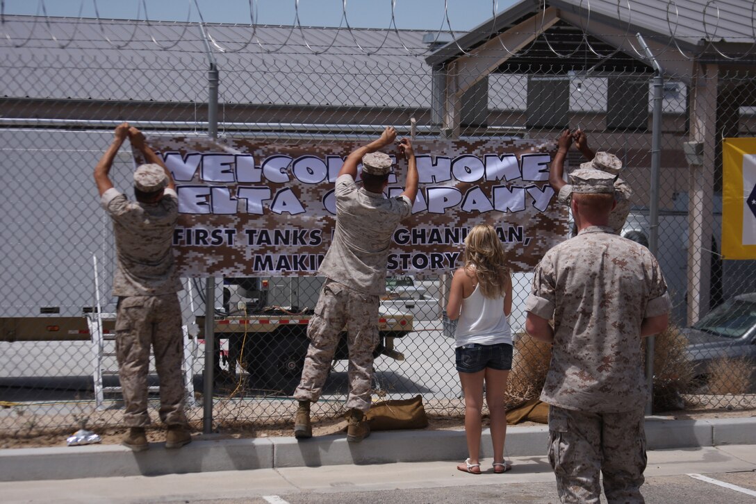 Friends hang signs to welcome Co. D, 1st Tank Battalion home from their tour in Afghanistan July 28, 2011.