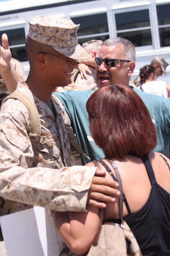 A family finally comes together in an emotional reunion after their son finishes his long tour in Afghanistan at the 1st Tanks homecoming July 28.