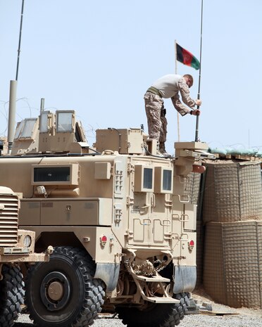 Sgt. Christopher T. Wehunt, a multi-channel equipment operator with 2nd Marine Logistics Group (Forward), tightens an antenna at Forward Operating Base Marjah, Afghanistan, July 28, 2011.  Wehunt is part of a three-man communication team that travels around Helmand province maintaining radios and other communication devices for explosive ordnance disposal teams.