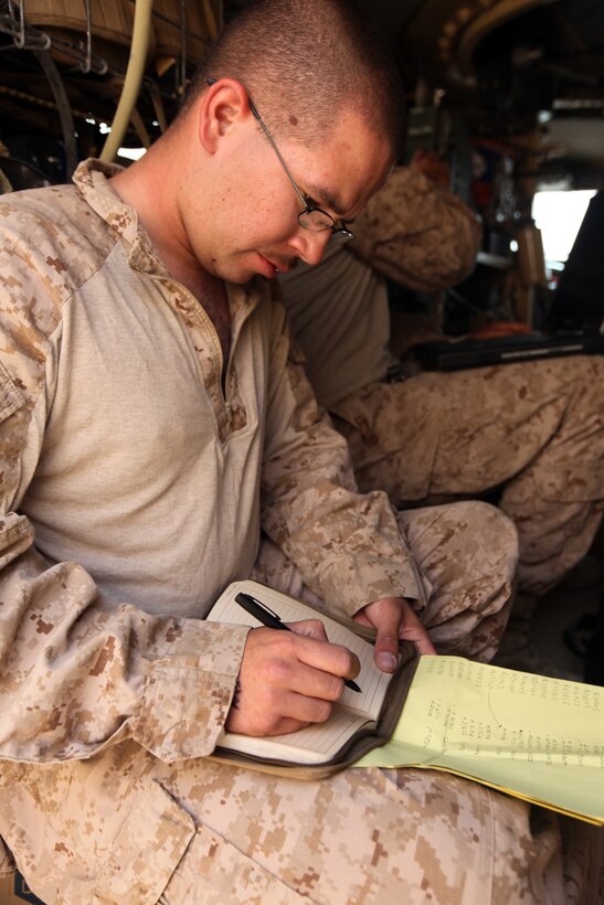 Cpl. Andrew S. Black, a ground radio intermediate repairer with 2nd Marine Logistics Group (Forward), writes down serial numbers and other information about radios before performing maintenance and installing upgrades at Forward Operating Base Marjah, Afghanistan, July 28, 2011.  Black is part of a three-man communication team that travels around Helmand province maintaining radios and other communication devices for explosive ordnance disposal teams.